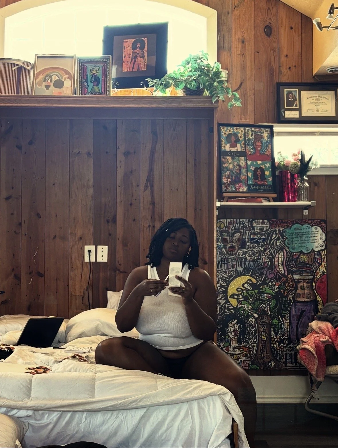 Kenya Brown in her creative rawness in her loft in the heart of Denton, surrounded by her original artwork, books and wood paneling.