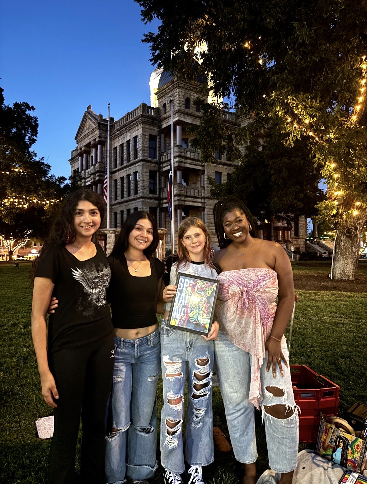 Kenya Brown, Denton Texas Local Artist smiling for a photo with inspired young women. After an amazing conversation and a purchase of her one of a kind art work, they share a smile and sweet goodbyes.