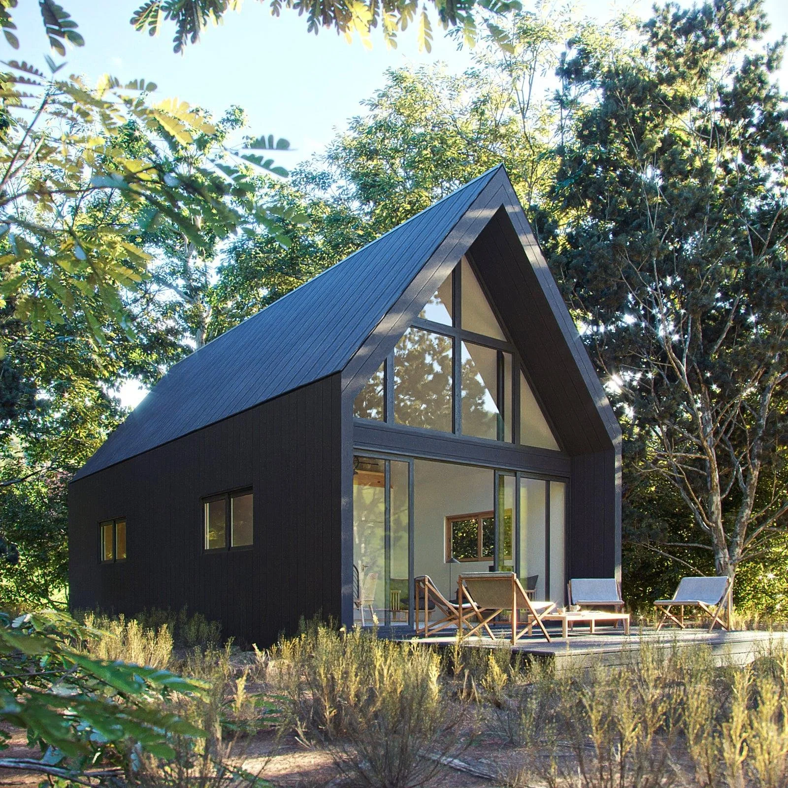 Modern black A-frame house with large glass windows, outdoor patio with chairs, surrounded by greenery and trees.