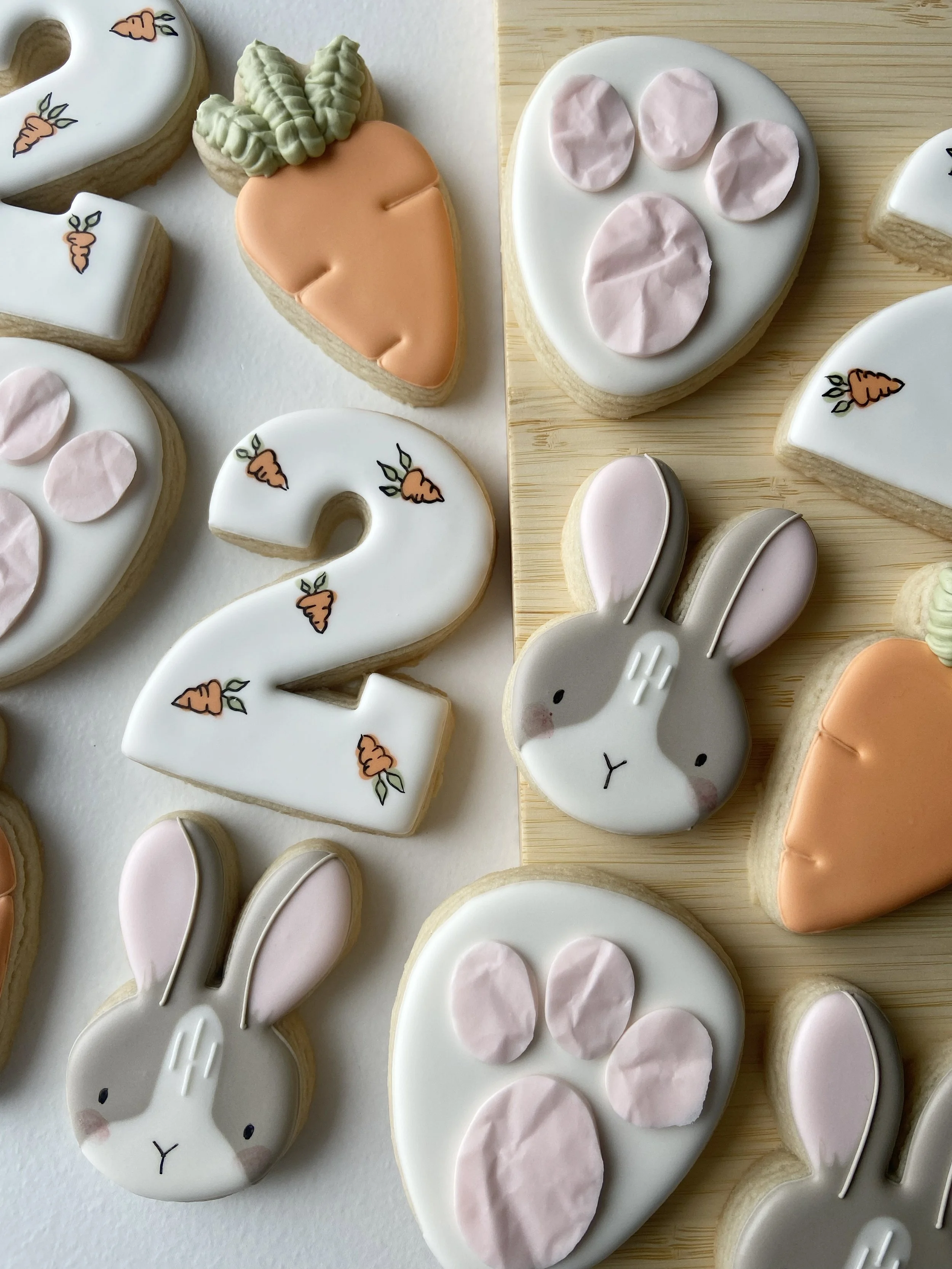 Easter-themed decorated cookies featuring bunnies, carrots, and paw prints.