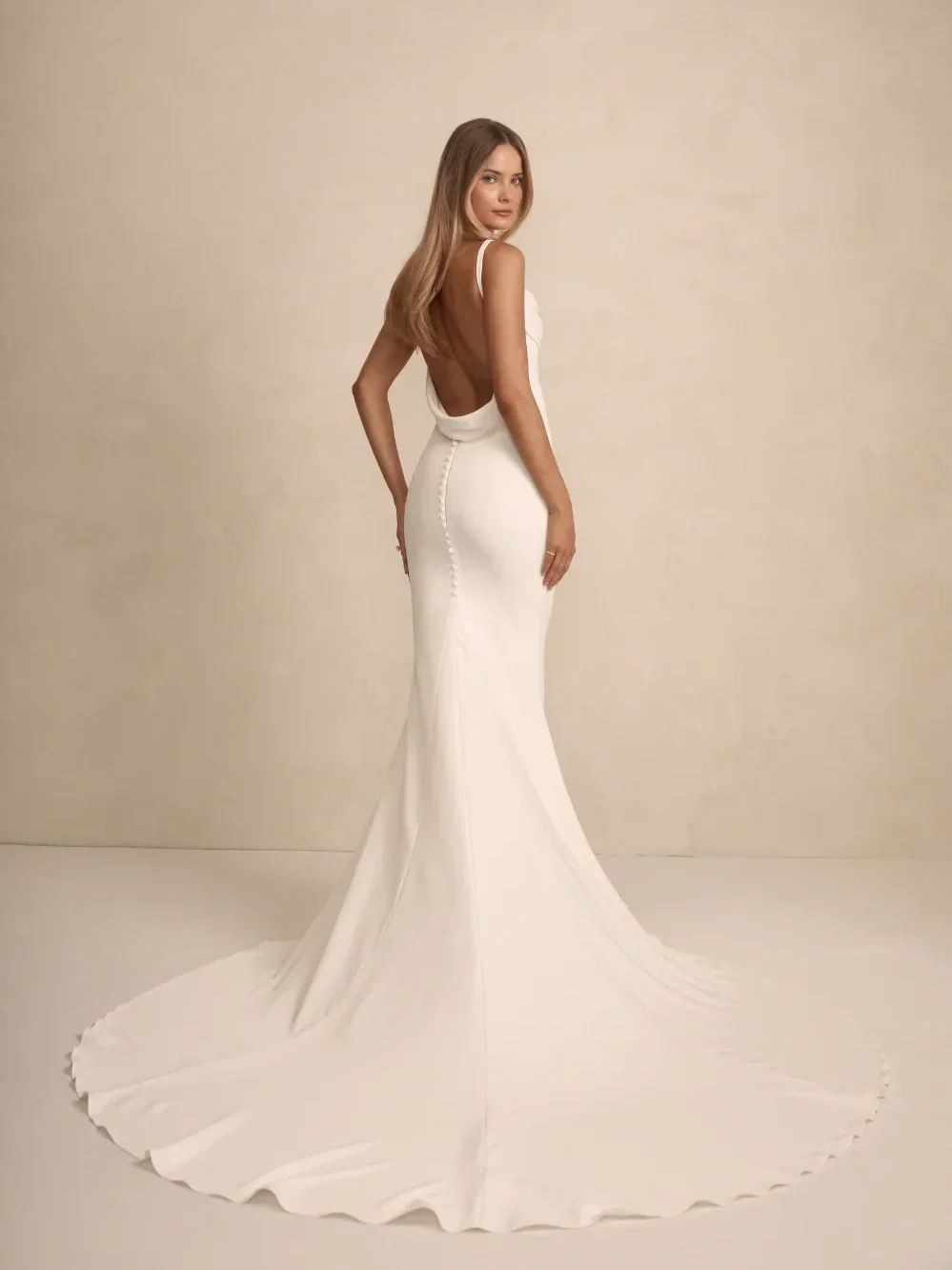 Figure framing buttons to the godet with iconic Archie cowl back