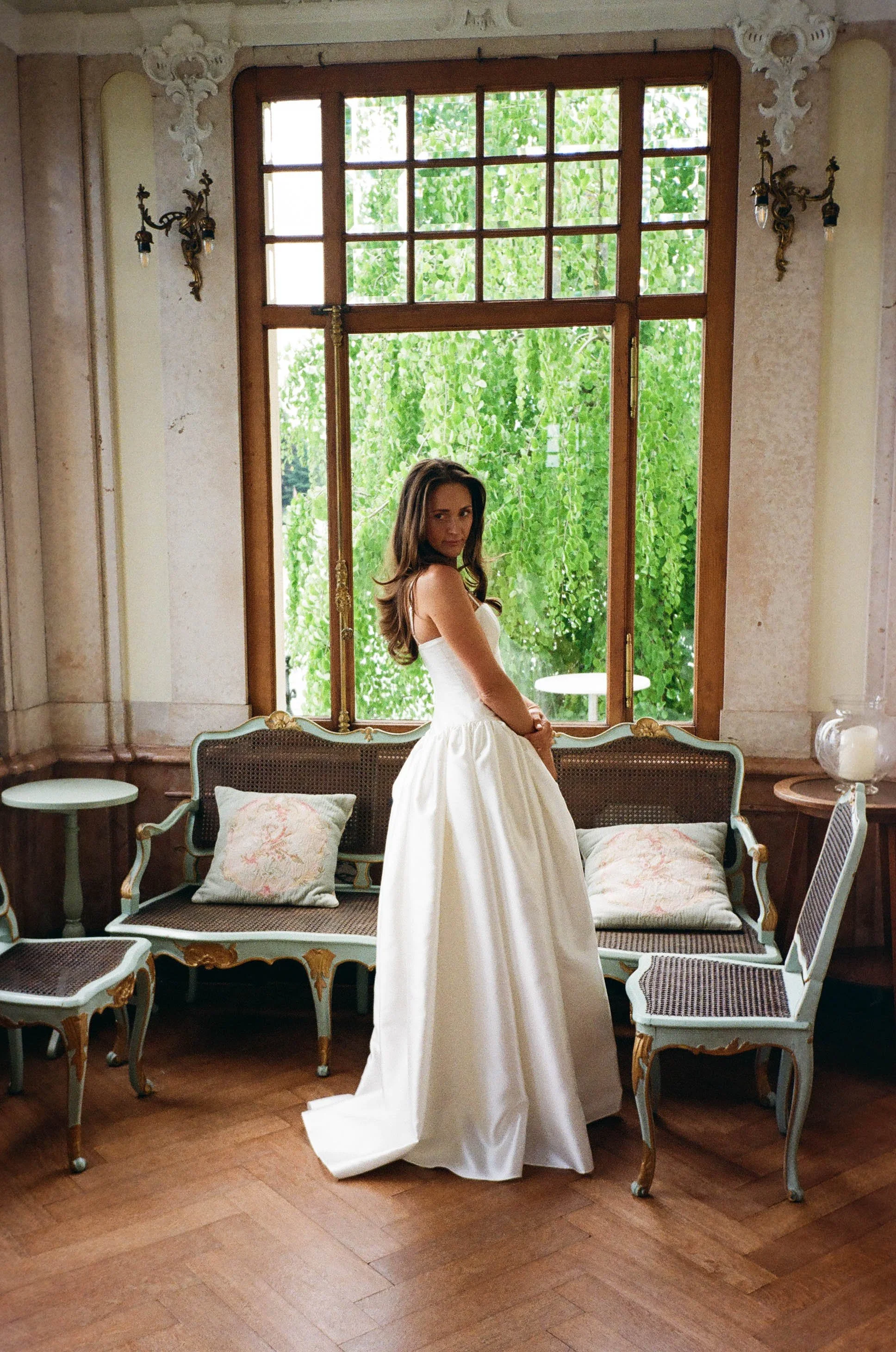 A bride captured at the getting ready in a romantic location with  vintage-style furniture and ornate wall decorations in Bend, Oregon. 