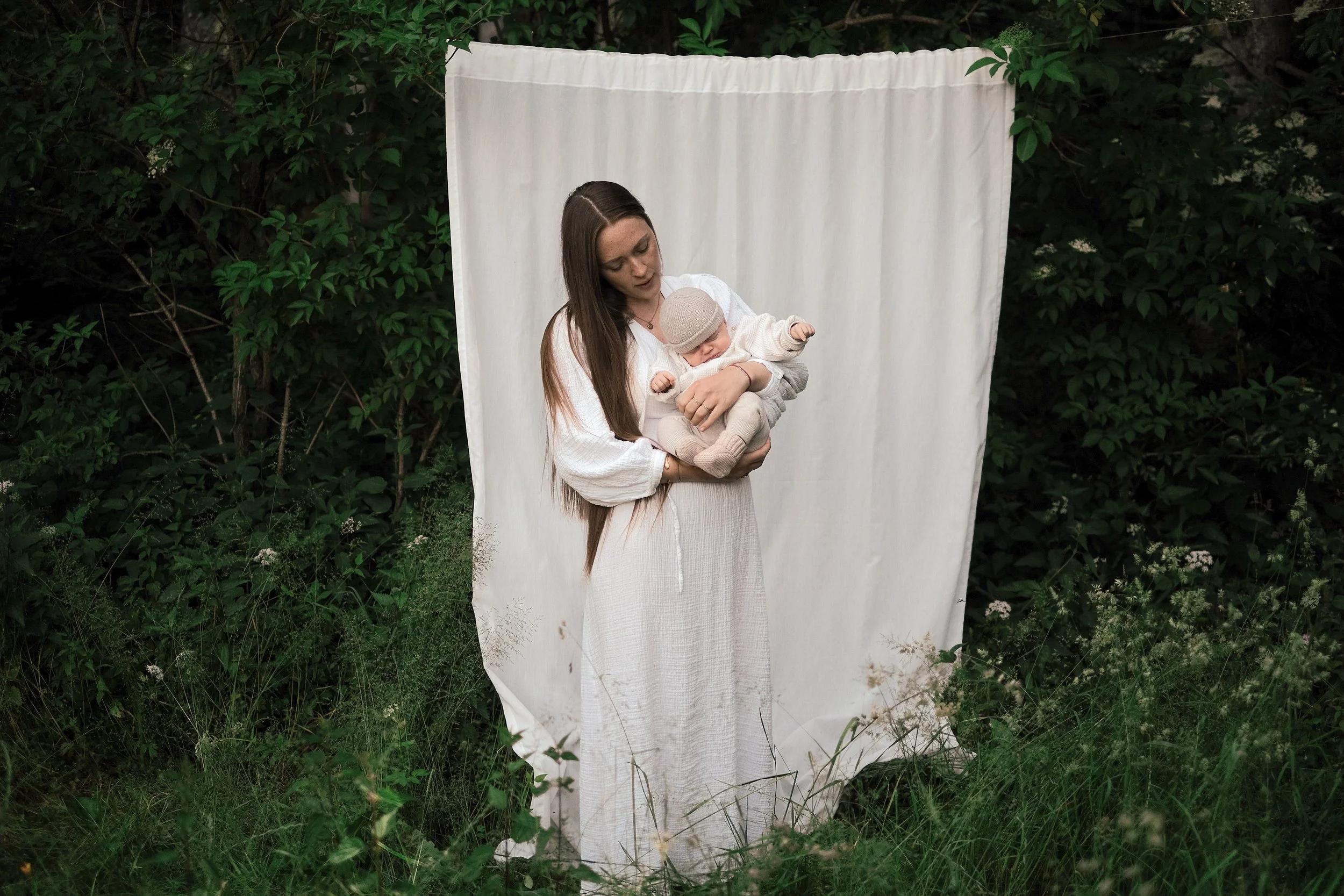 newborn baby and mother outside