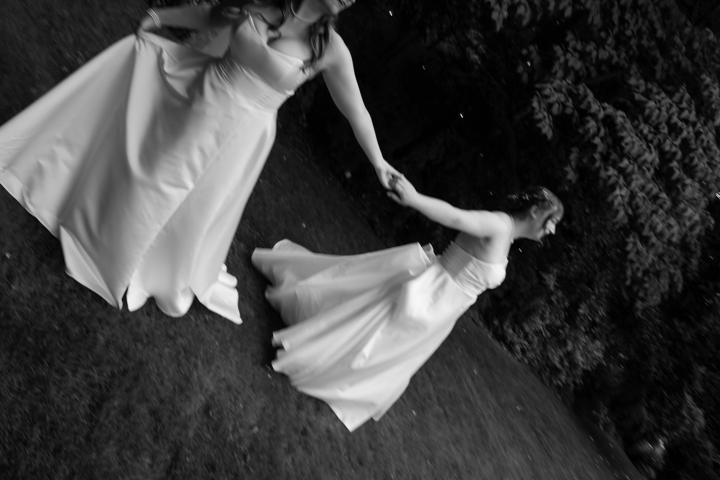 Two brides on a LGBQ  wedding with white captured in a real, intimate moment.