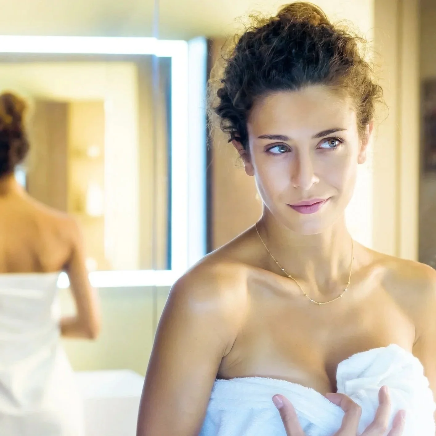 Bride preparing her skin before the wedding, mirror reflection