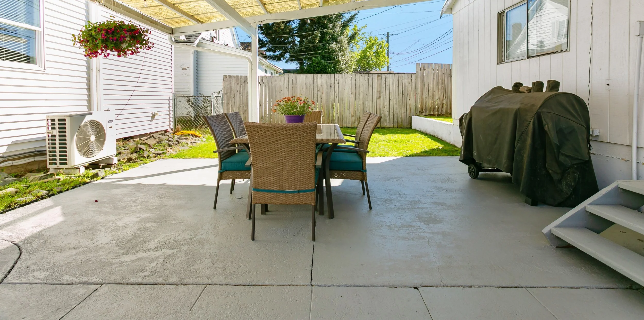 Covered patio with freshly painted concrete is ready for your next gathering!