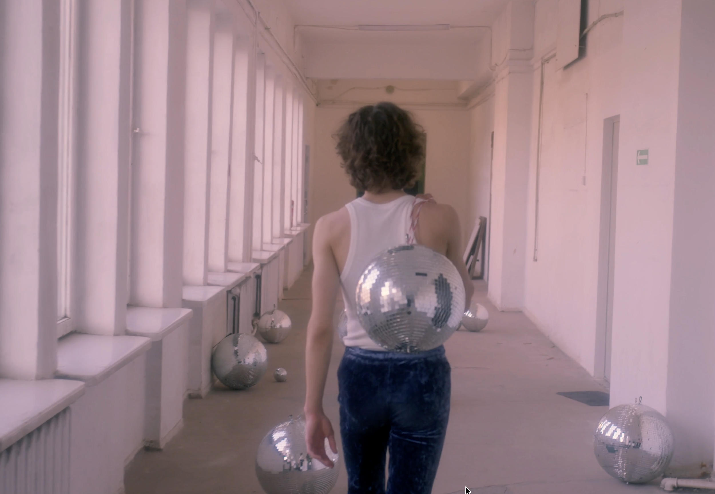 man walking with disco ball still.png