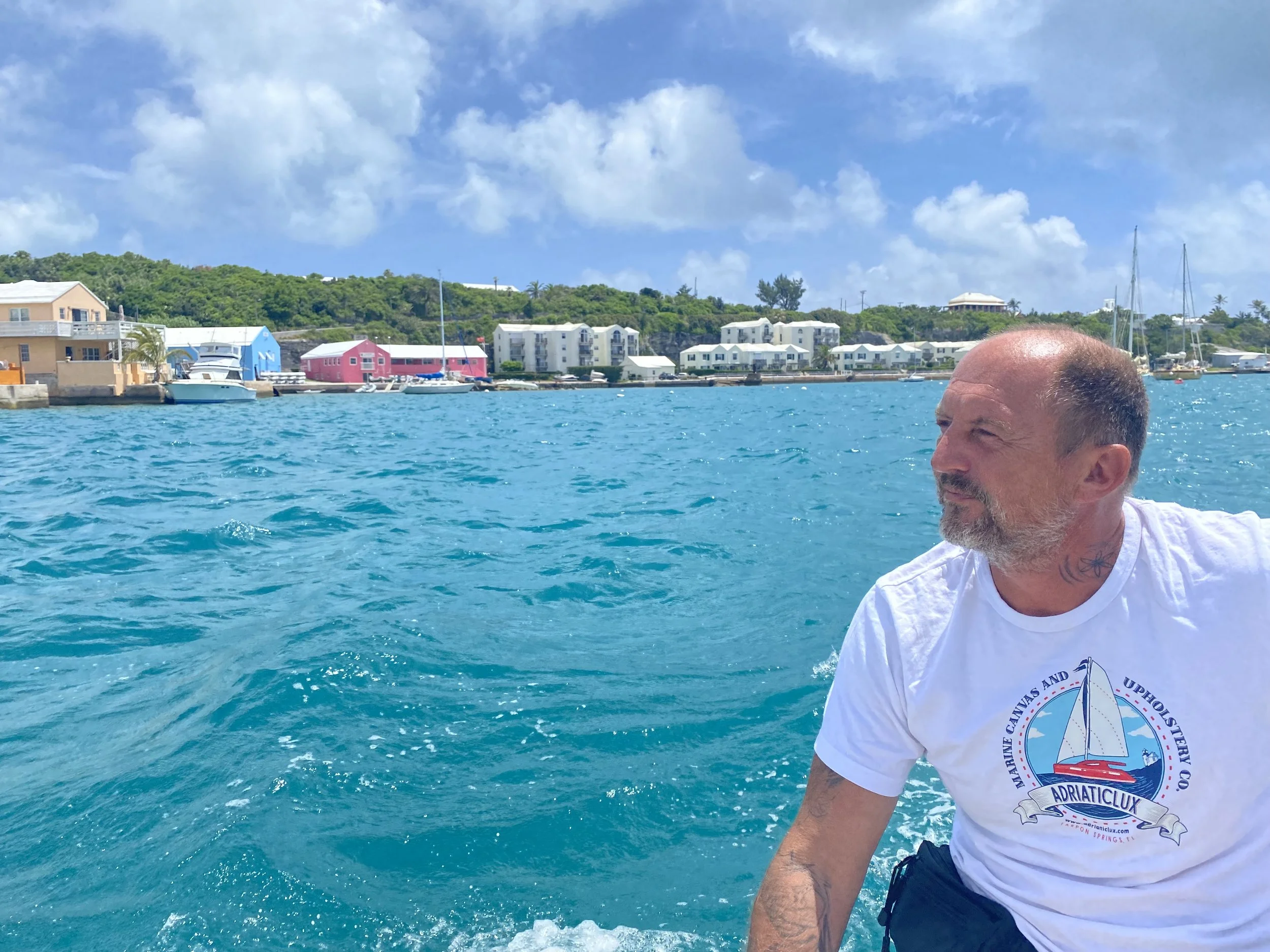 Peck enjoys a quiet moment cruising in a dinghy through the crystal-clear blue waters of St. George’s, Bermuda. This photo captures a peaceful pause during an Atlantic crossing, highlighting the beauty of Bermuda and the simple joy of life at sea.