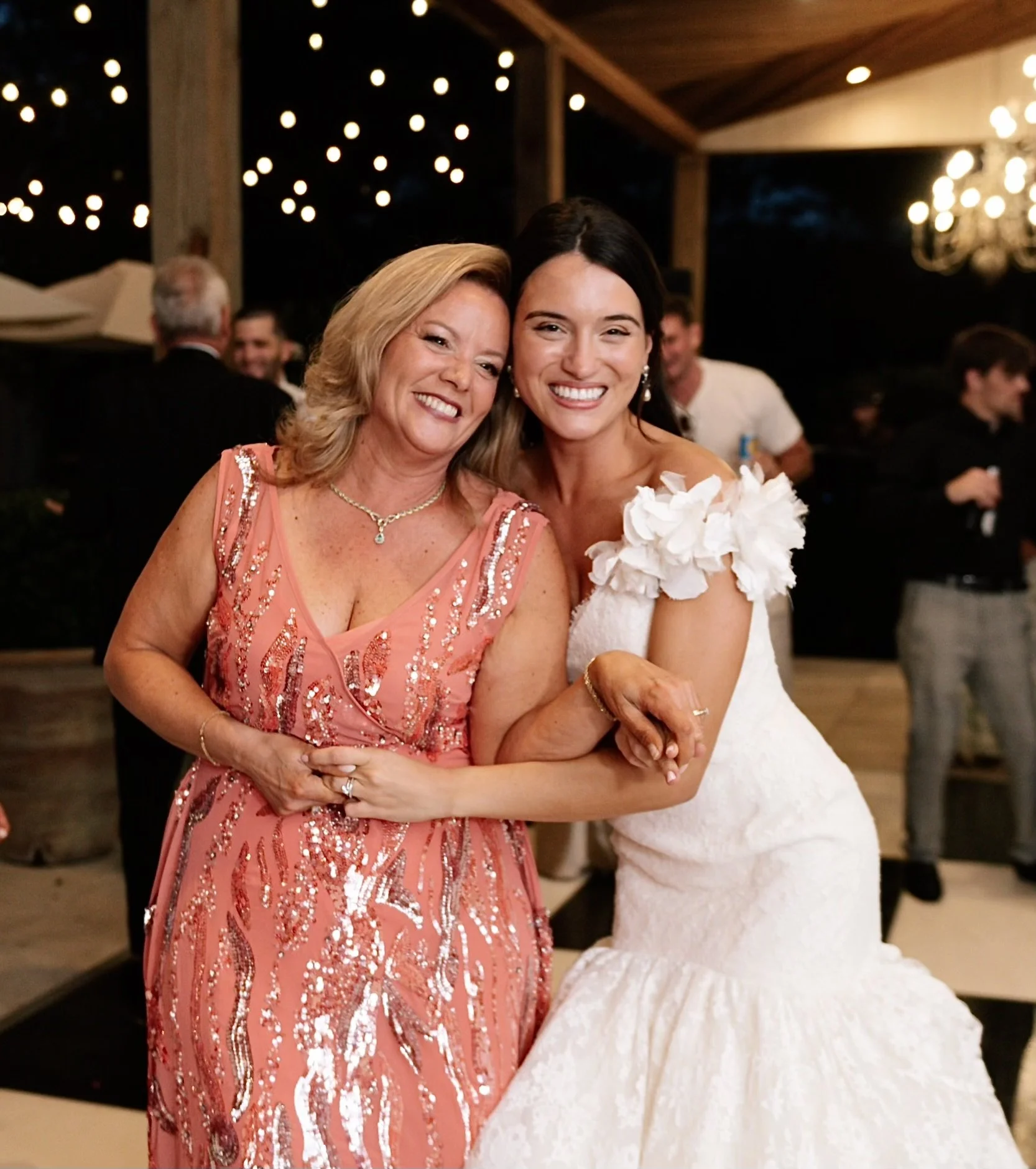 Bride wearing her aunt's vintage wedding dress dancing with her aunt