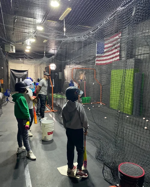 Young athletes waiting their turn in the batting cages at The Mound Training Facility.