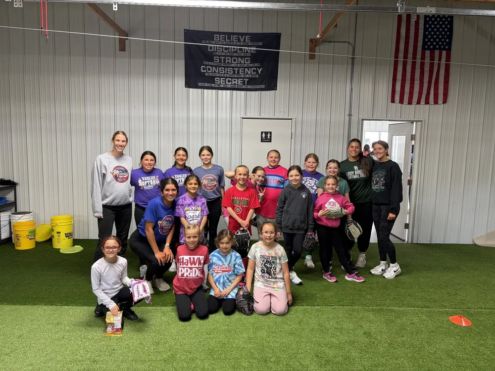 Group of young softball athletes and coaches after a training clinic at The Mound Training Facility in Oglesby, IL.