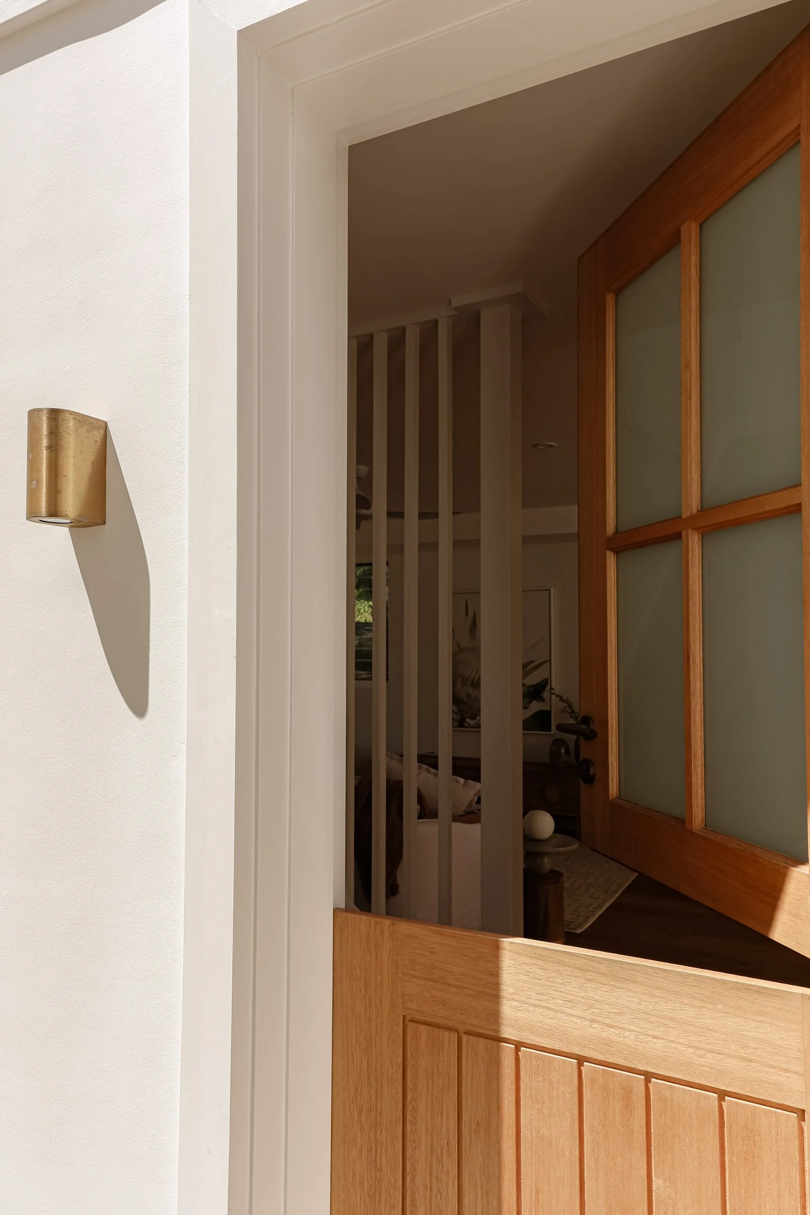 timber stable door, bushed brass exterior light, white house exterior, peering into inside home, timber slat feature