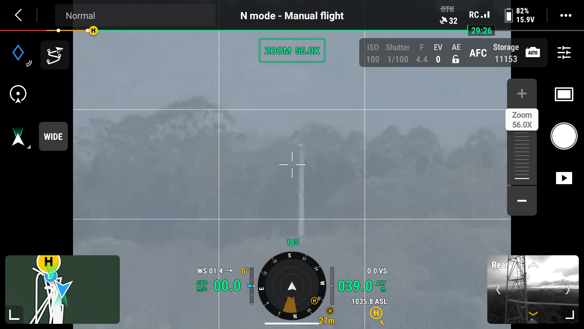 View from a drone or aircraft camera showing smoke rising from a distant fire with clouds in the sky. The interface overlay indicates it is in manual flight mode, with zoom level 56.0X, and various flight data including altitude, speed, and compass heading.