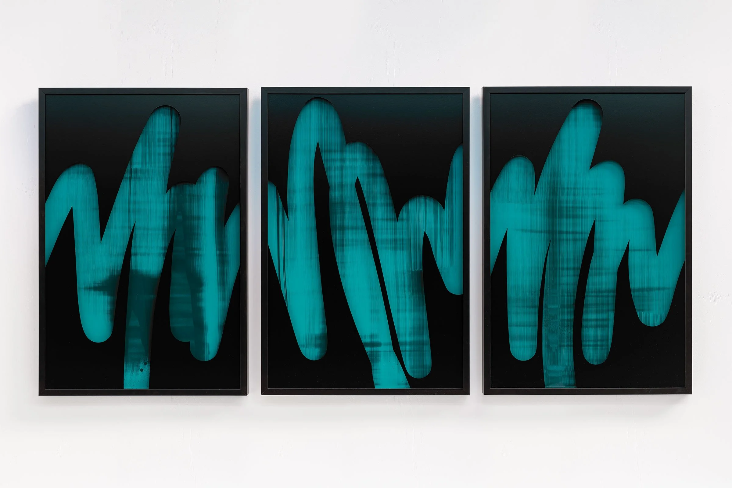 Christchurch, New Zealand artist, Nathan Ingram's Triptych abstract art pieces with black backgrounds and blue, painted, brushstroke-like lines, framed and hung on a white wall.