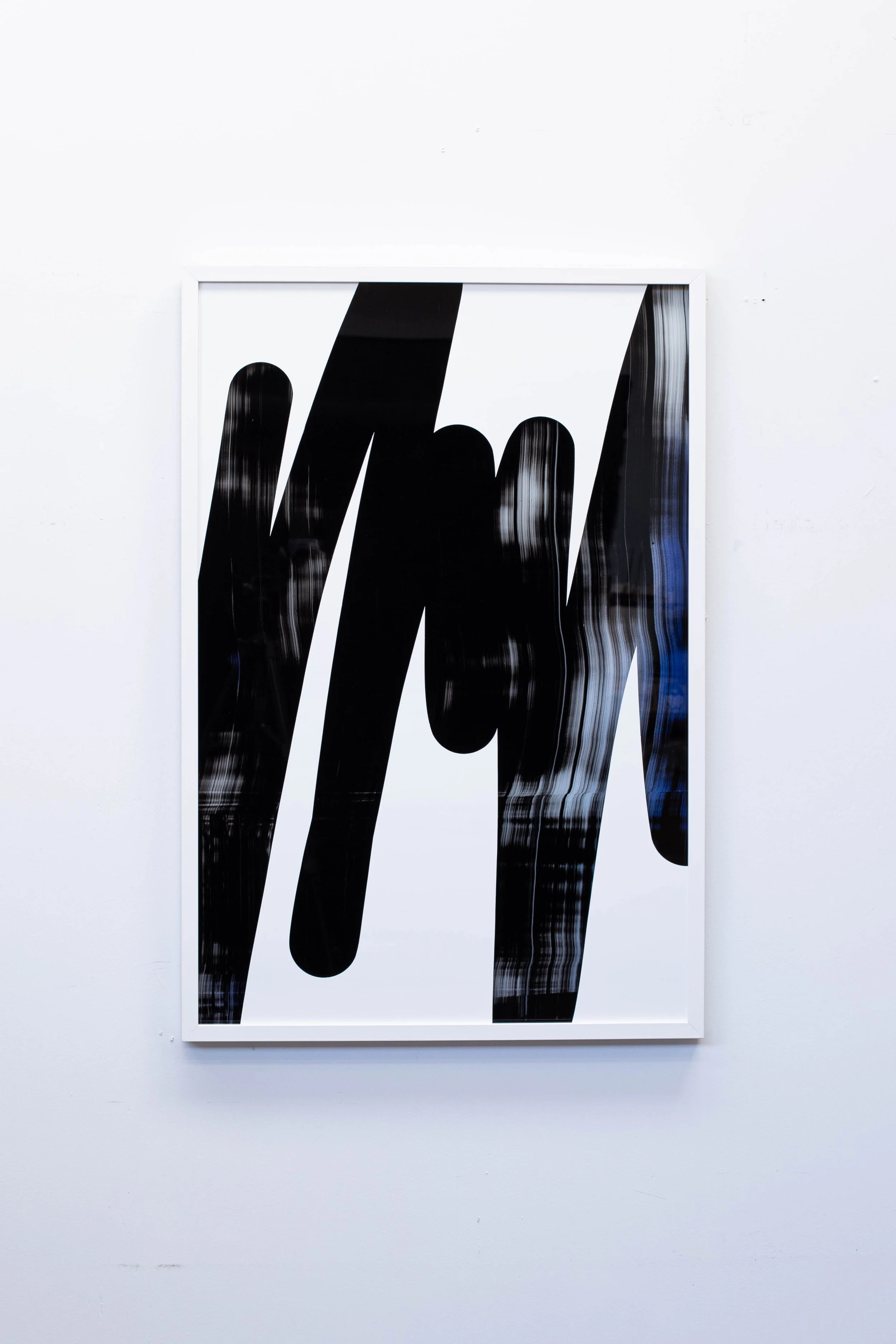 Christchurch, New Zealand artist, Nathan Ingram's Abstract black and white art piece with bold, jagged shapes on white background, framed.