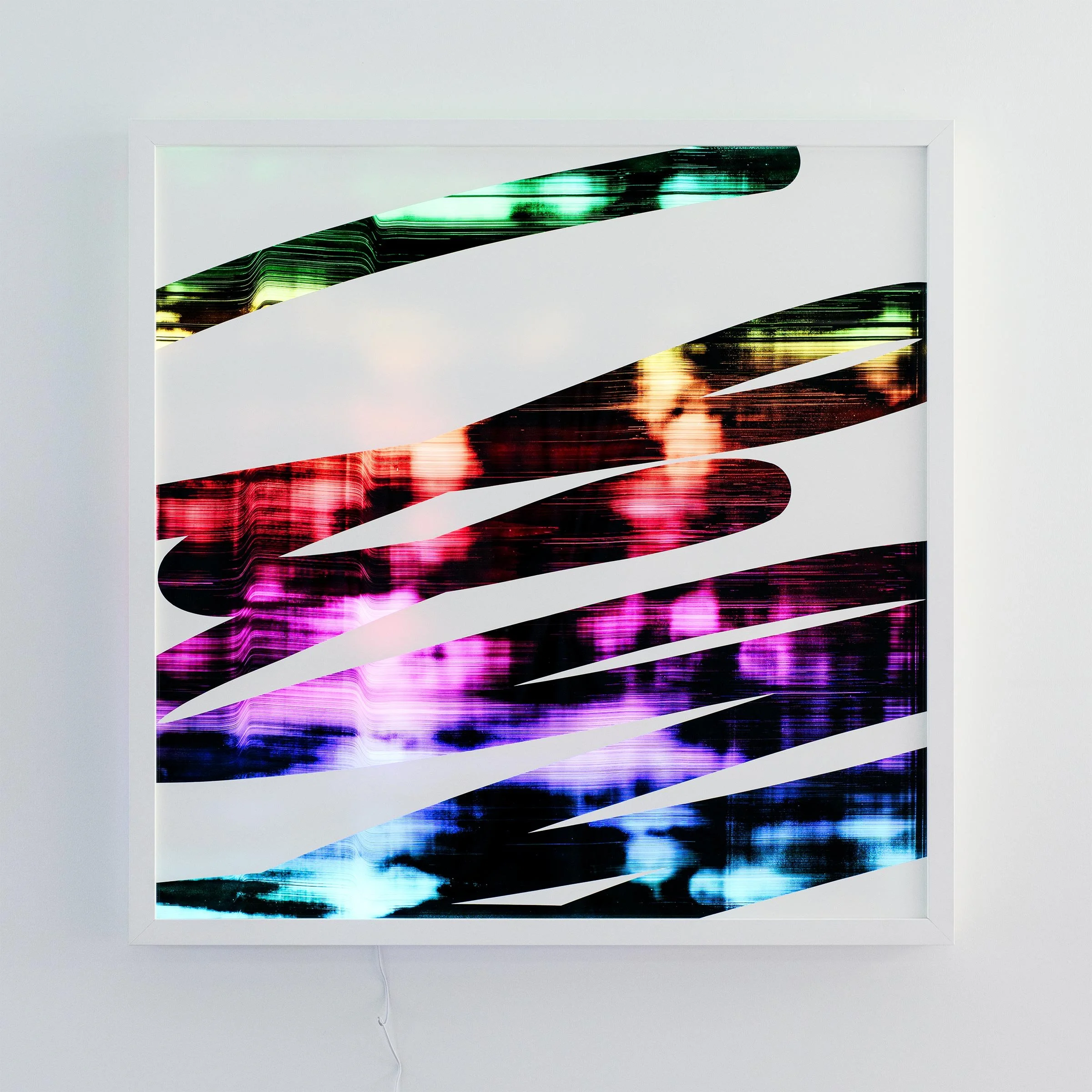 Christchurch, New Zealand artist, Nathan Ingram's Colorful abstract lightbox art installation with horizontal cutouts on a white wall, displaying vibrant multicolored lights and patterns behind it.