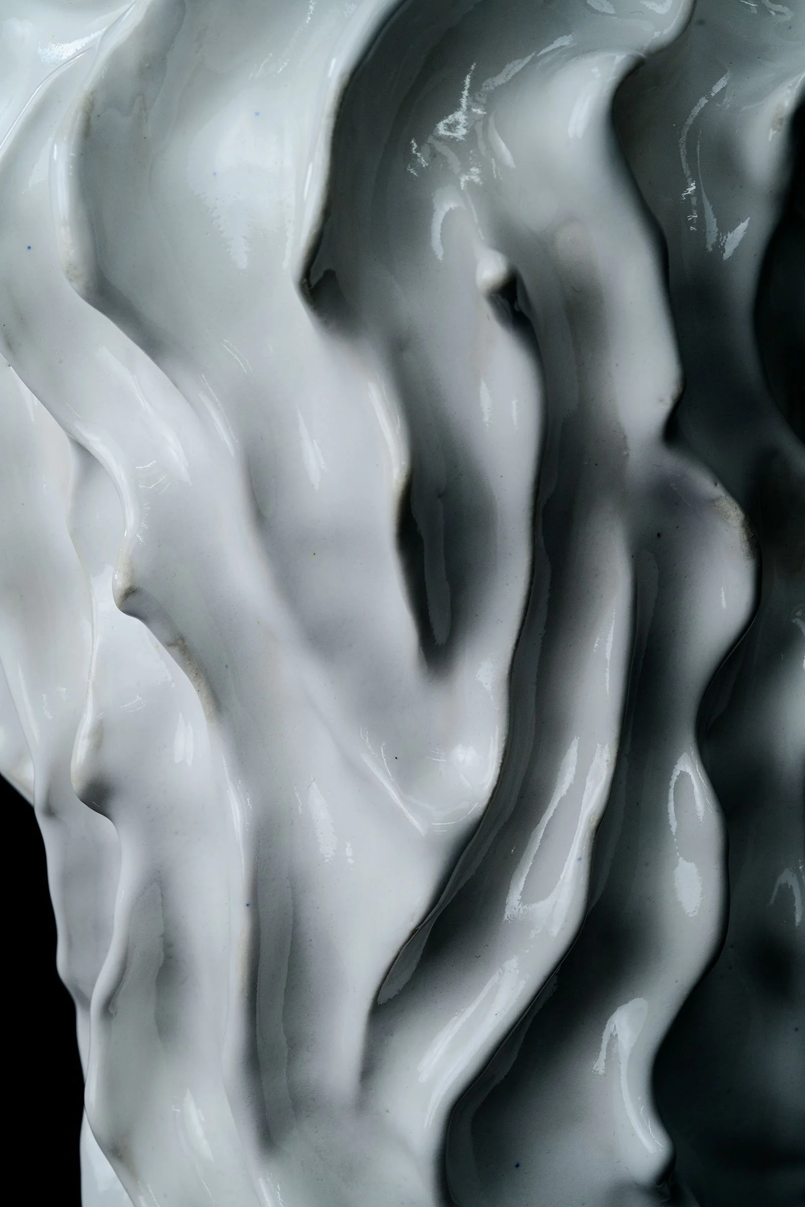 Christchurch, New Zealand artist, Nathan Ingram's close-up of thick, flowing, white and black paint or glaze with glossy texture and wavy pattern