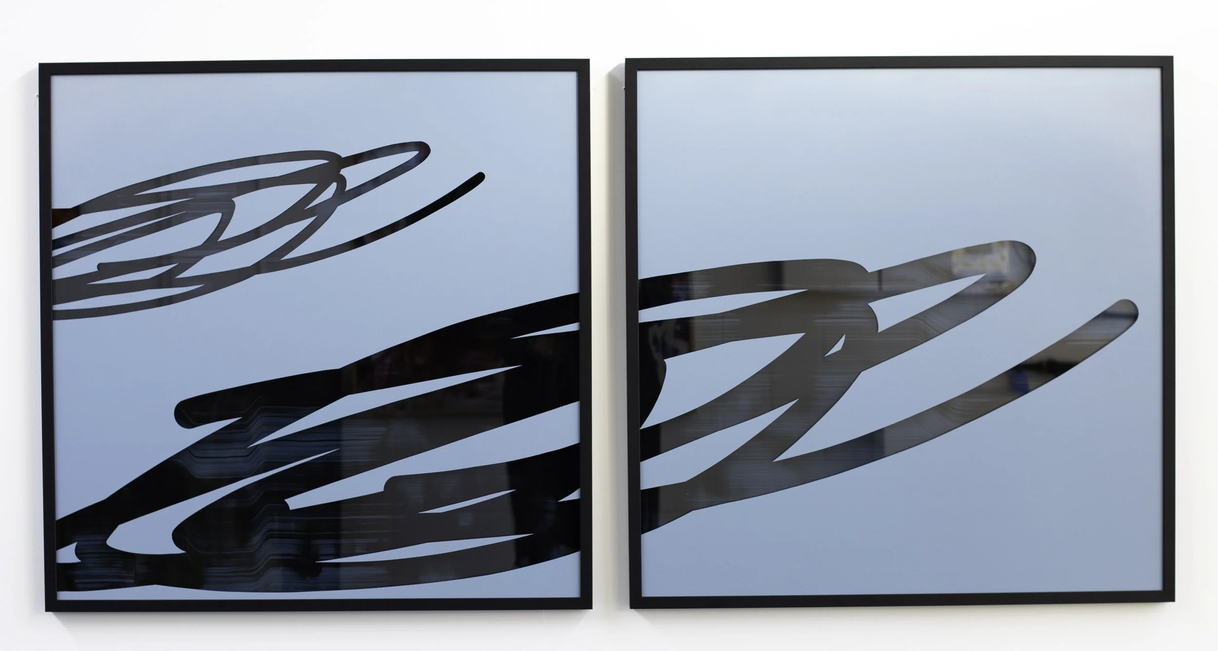 Christchurch, New Zealand artist, Nathan Ingram's Two framed abstract art pieces featuring black line designs on a light blue background, hung side by side on a white wall.