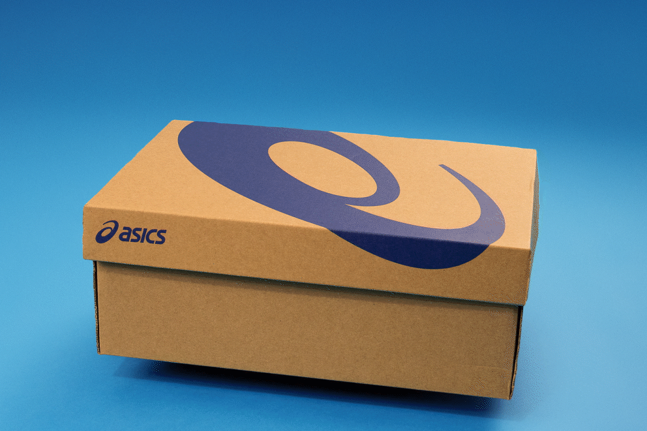 Stop motion animation of cardboard shoe box with sneakers animating out, placed on a blue background.
