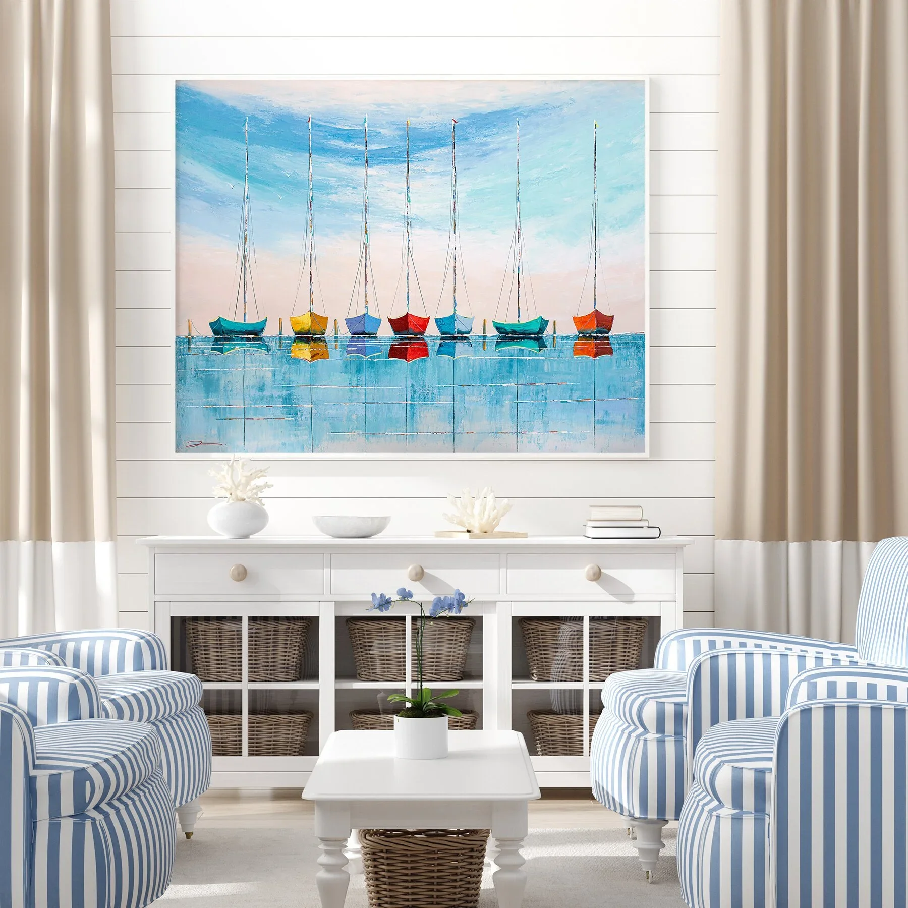 Living room with a large wall art of colorful sailboats on water, white cabinet with wicker baskets, striped armchairs, white coffee table with a potted orchid, and beige curtains.