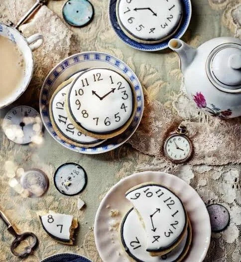 a tea party with biscuits that look like clocks