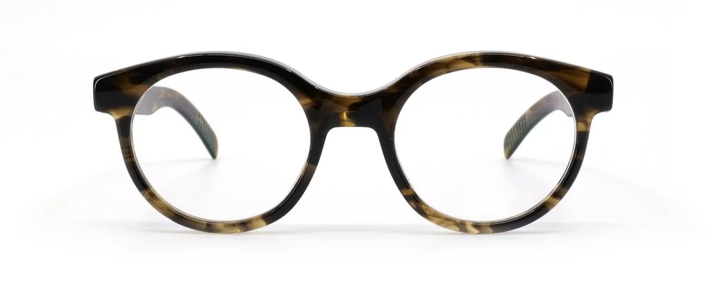 A pair of tortoiseshell eyeglasses with round frames on a white background.
