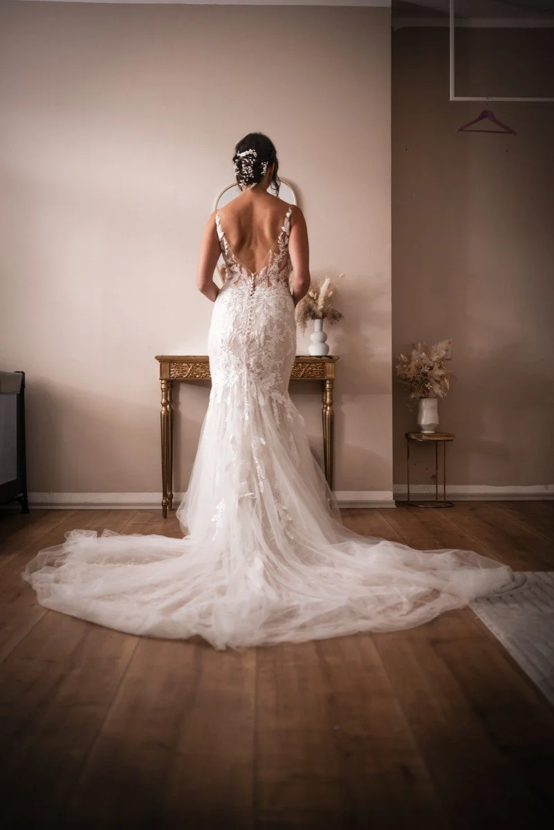 Eine Braut im Hochzeitskleid vor einem Spiegel – Originalaufnahme von Terramagika
