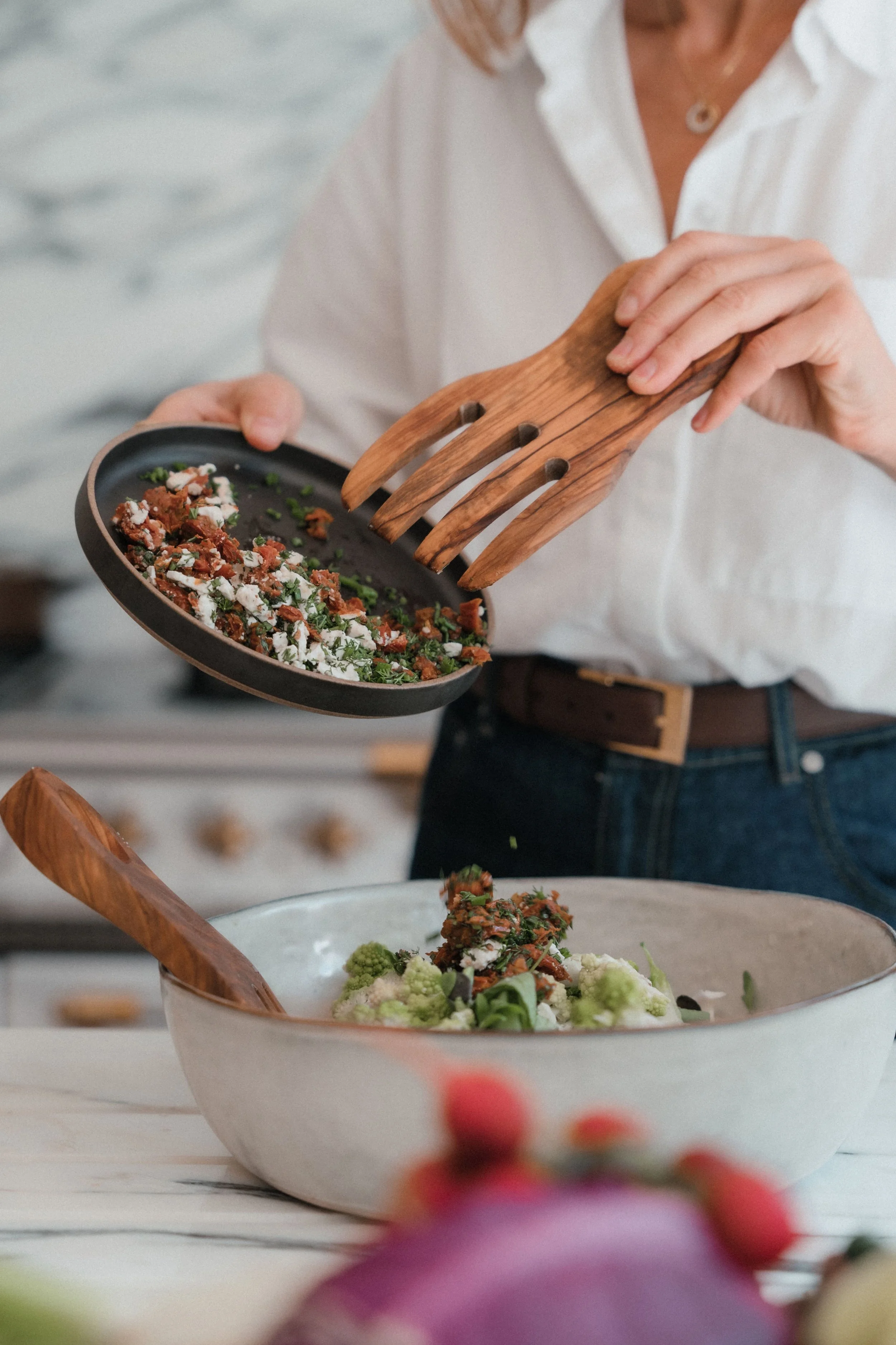 Midlife woman calmly cooking a healthy meal in her kitchen to support gut health and ease strange perimenopause symptoms