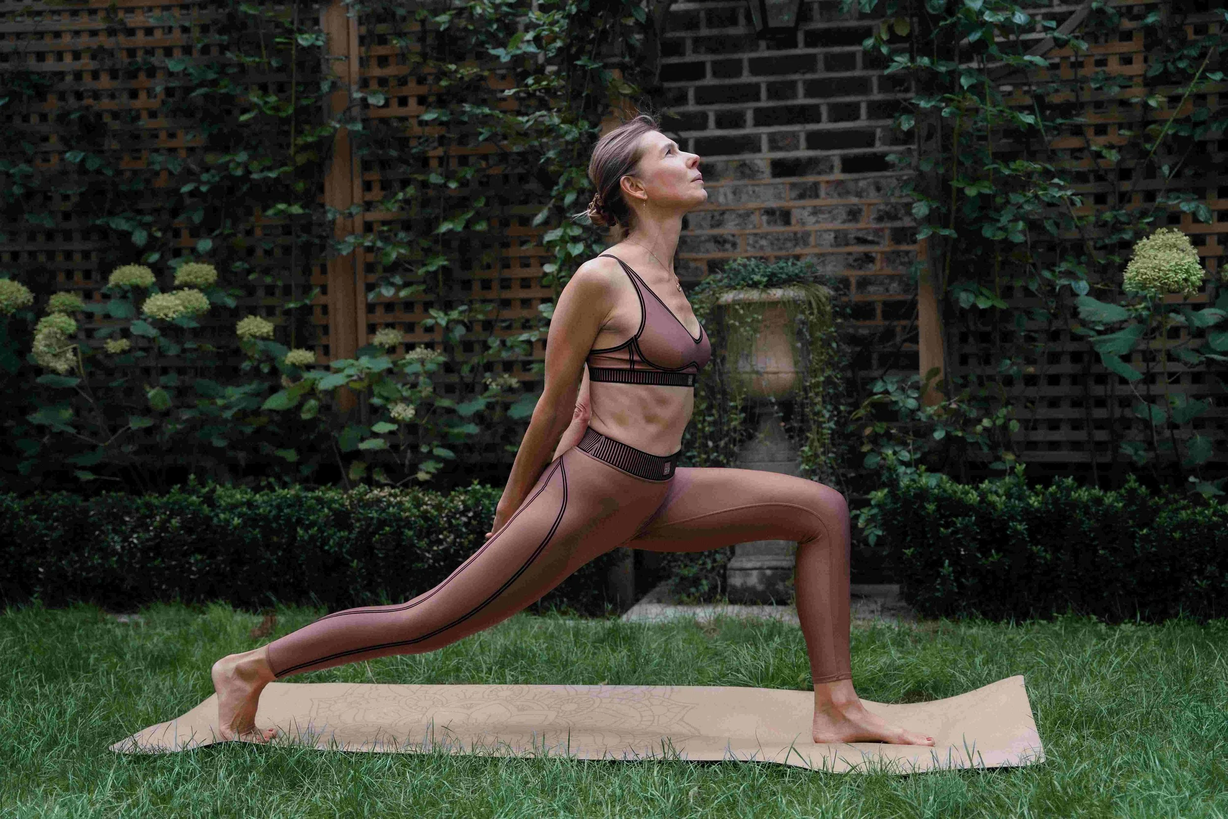 Yoga woman practising deep breathing to ease menopause bloating and belly bloat.