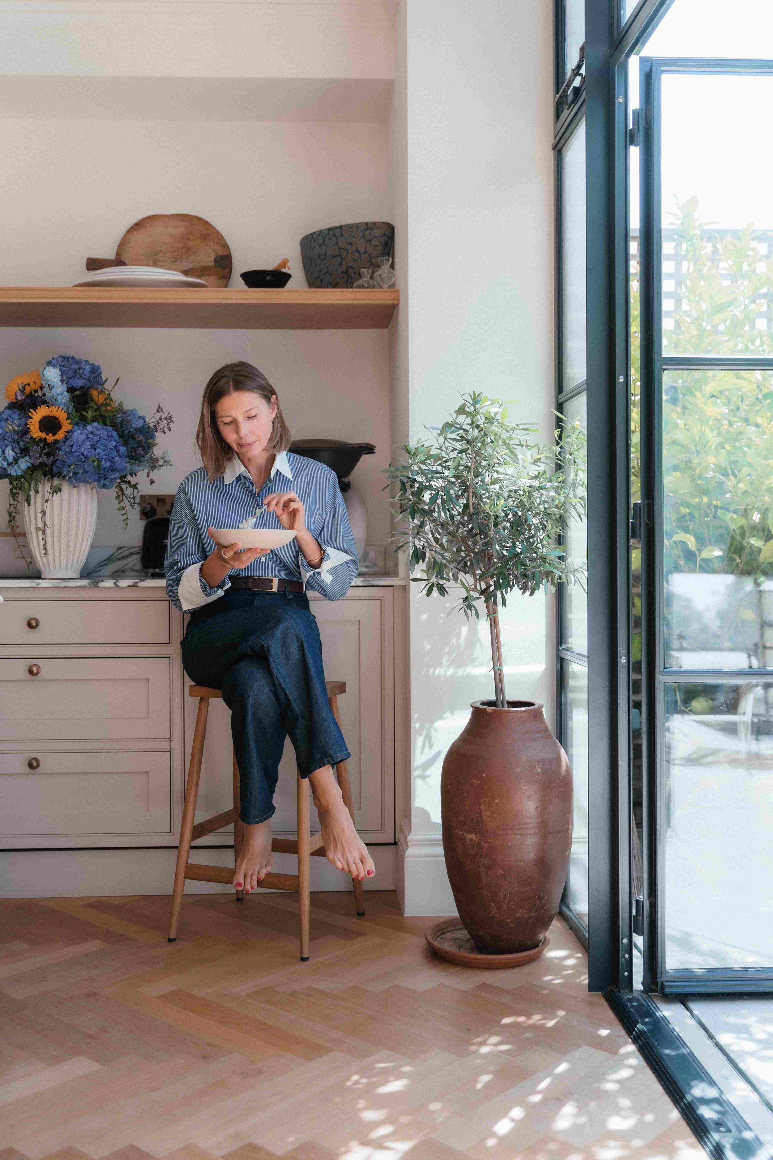 Woman eating a light meal feeling relieved from bloating.