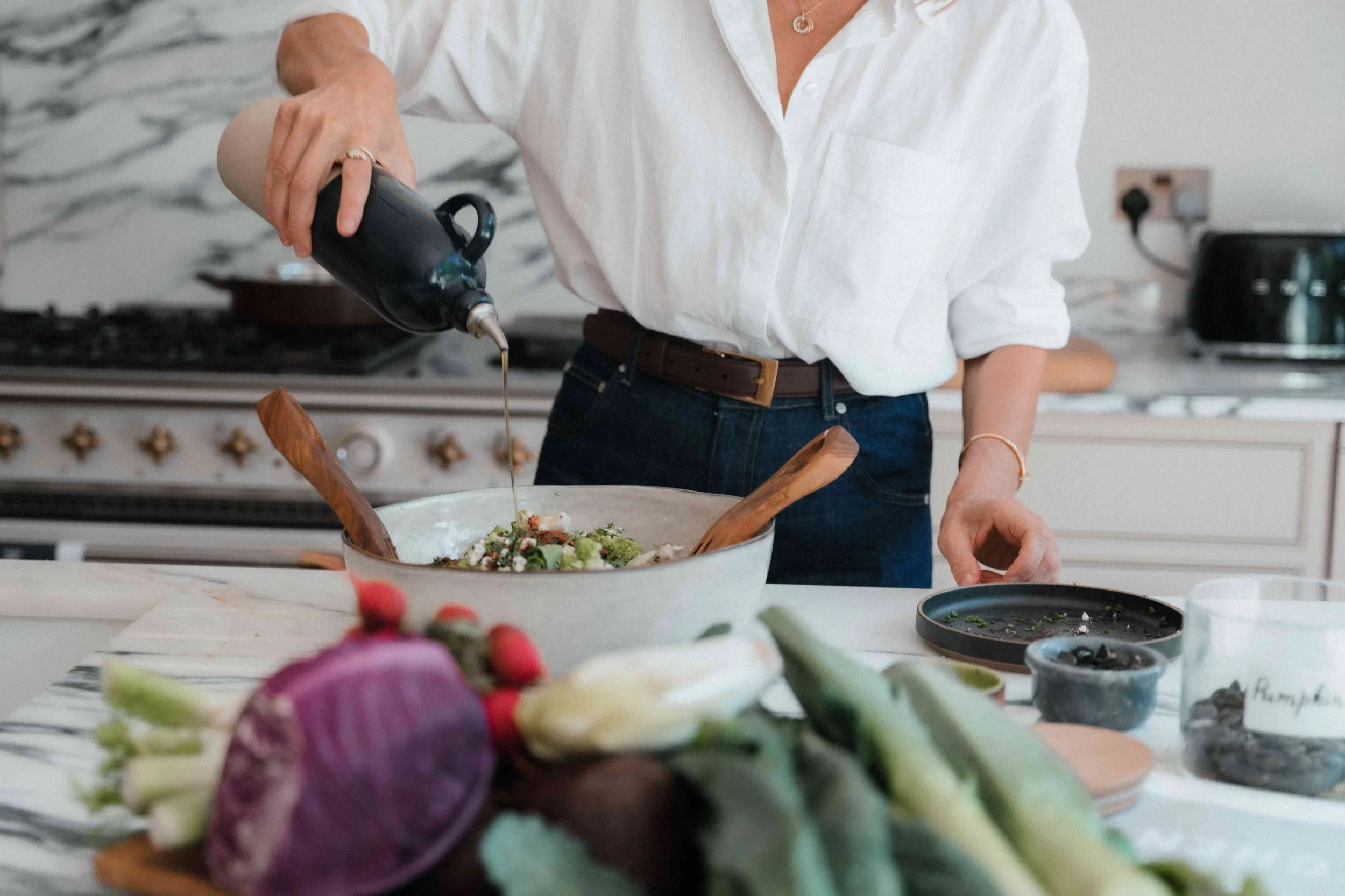 Woman cooking at home feeling relief from menopause bloating