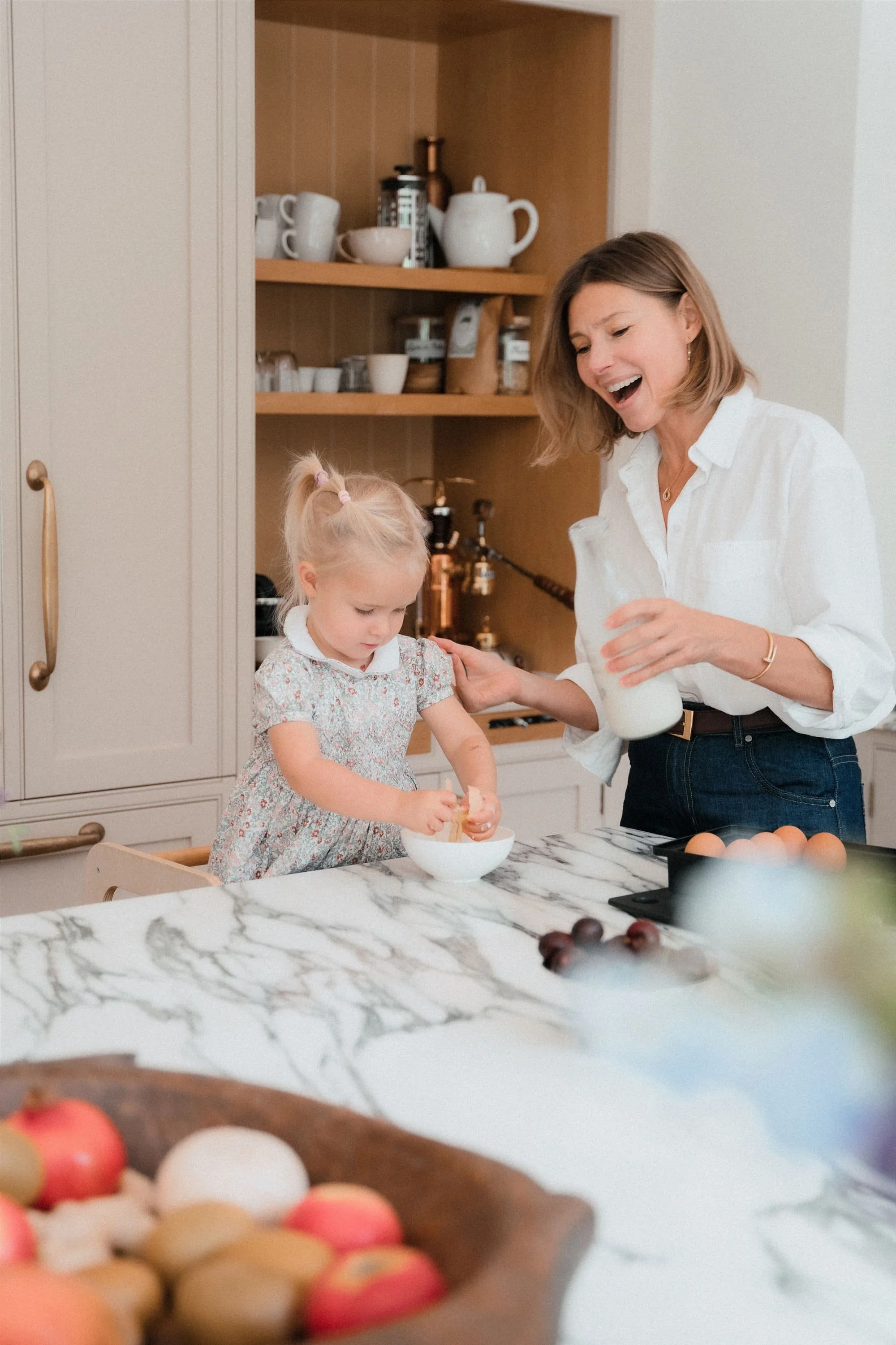 Midlife mother with her daughter cooking healthy food together at home, learning how nutrition can ease strange perimenopause symptoms