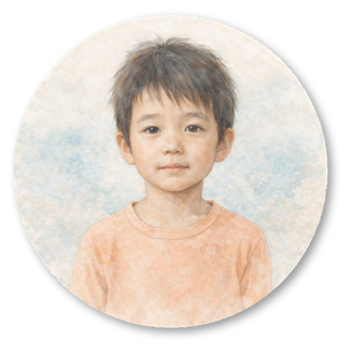 A young boy with dark hair and a neutral expression, wearing an orange shirt, in front of a soft, light-colored background.