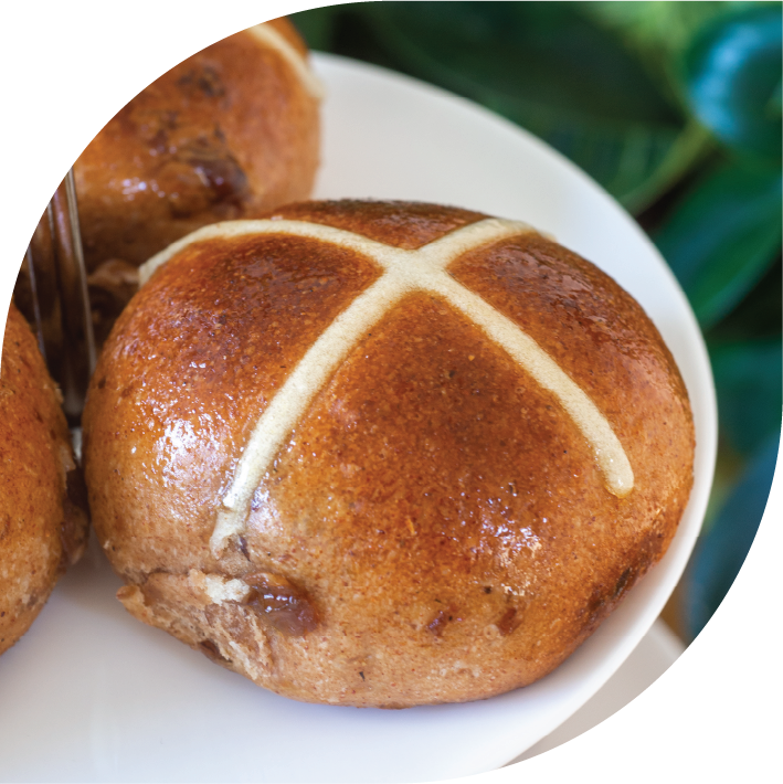 a fruit-filled hot cross bun