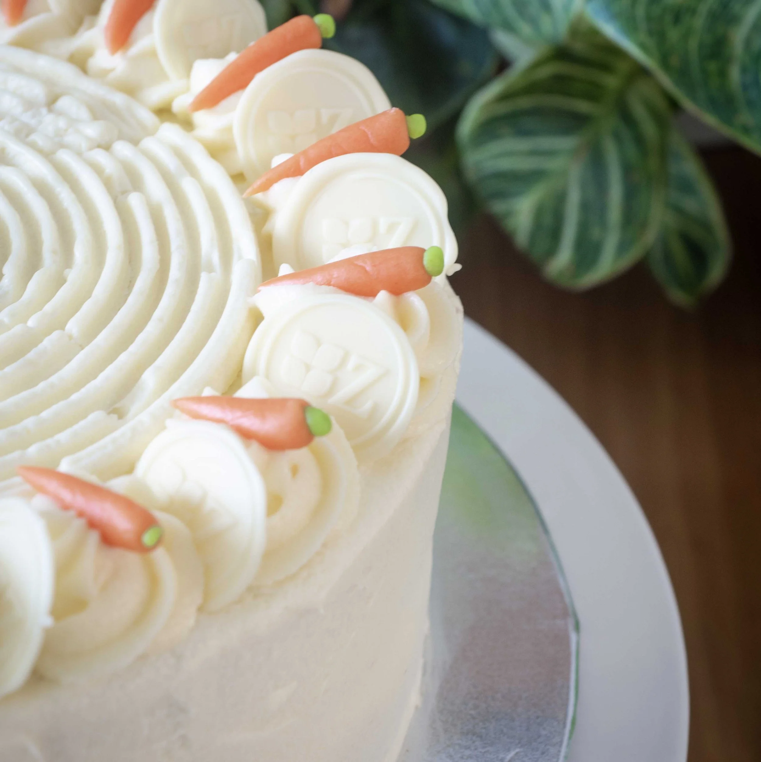 a close up of a carrot cake with mini marzipan carrot decorations