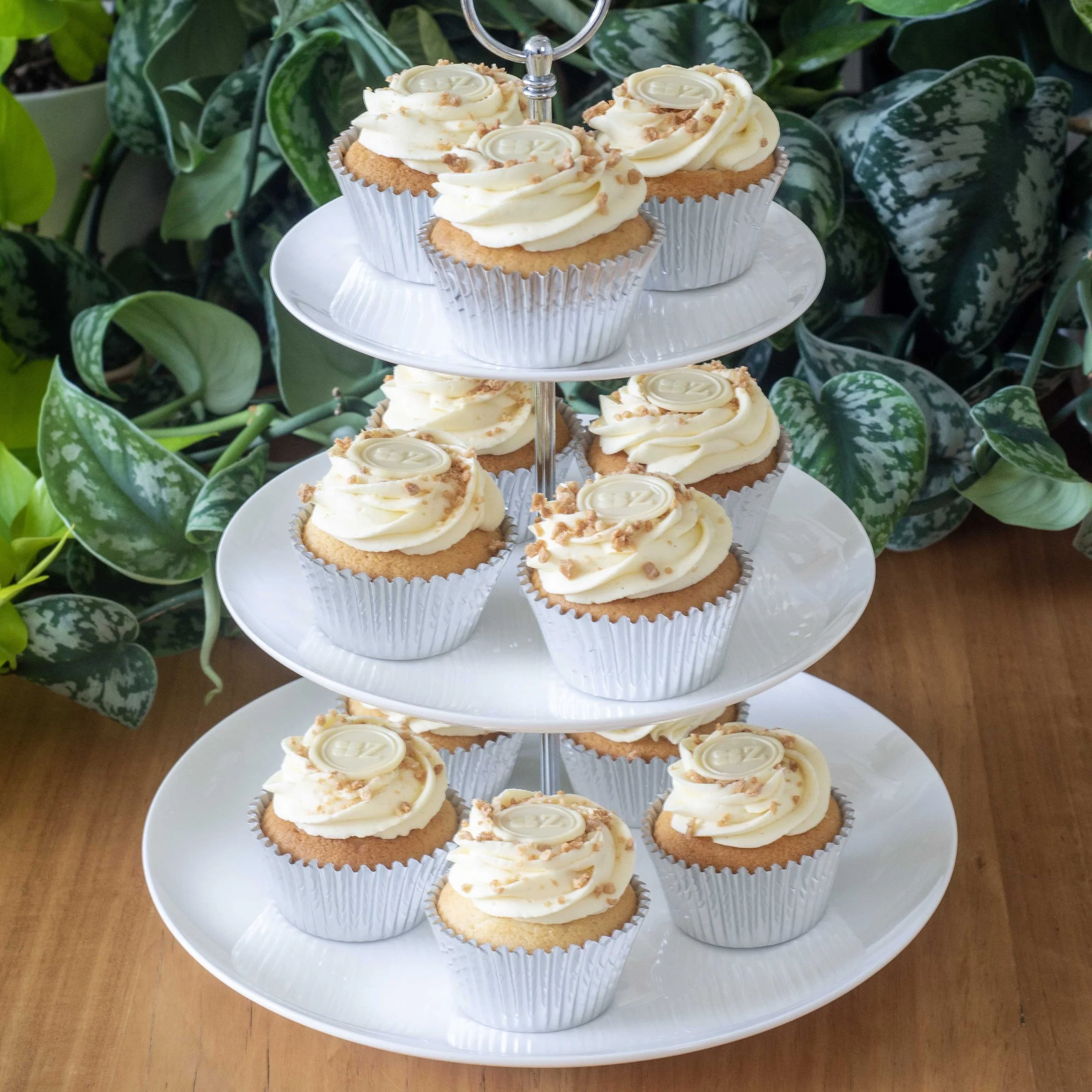 a cake stand with zitronen sahne (lemon cream) cupcakes