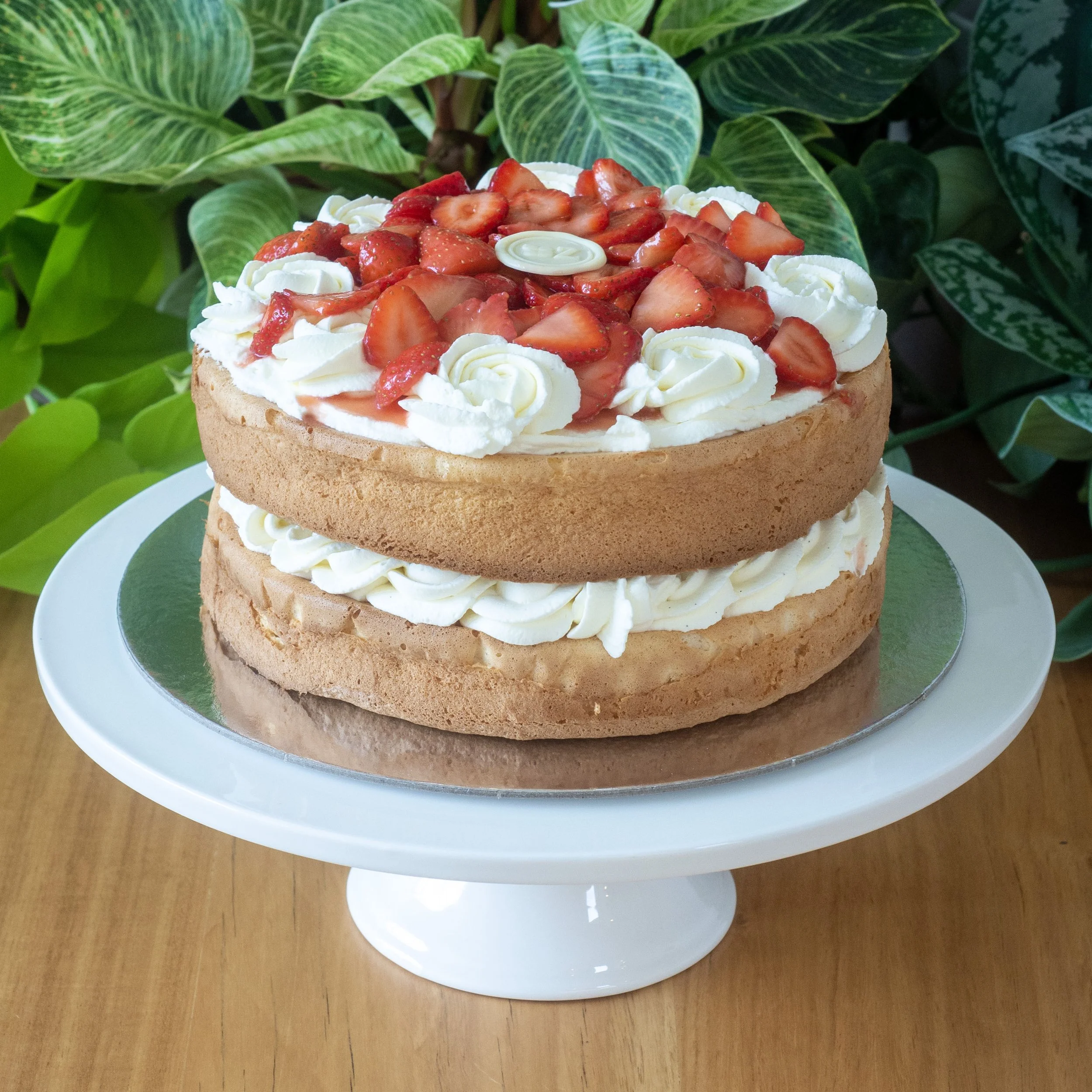 a fancy British Victoria Sponge with macerated strawberries