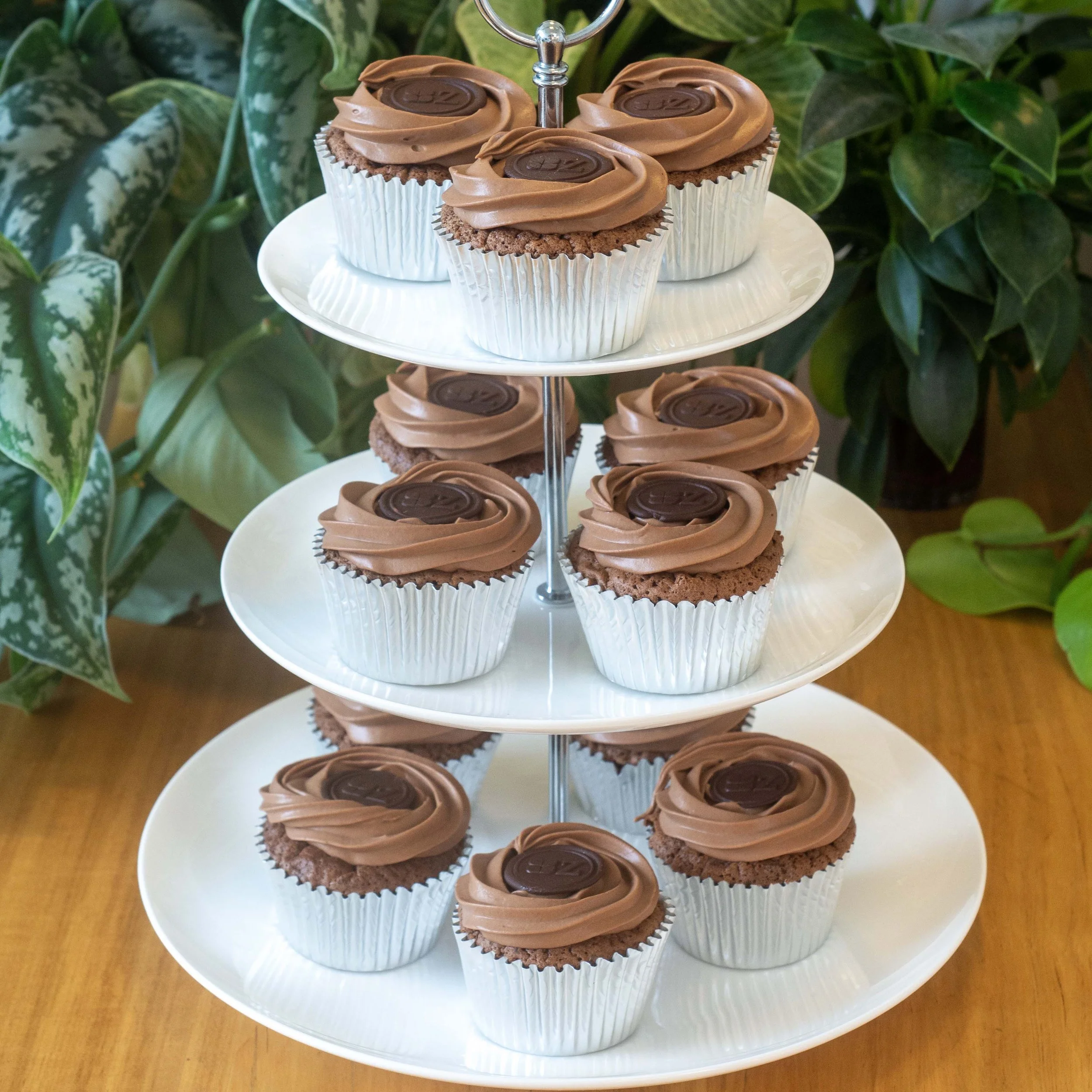 a cake stand of sachertorte cupcakes