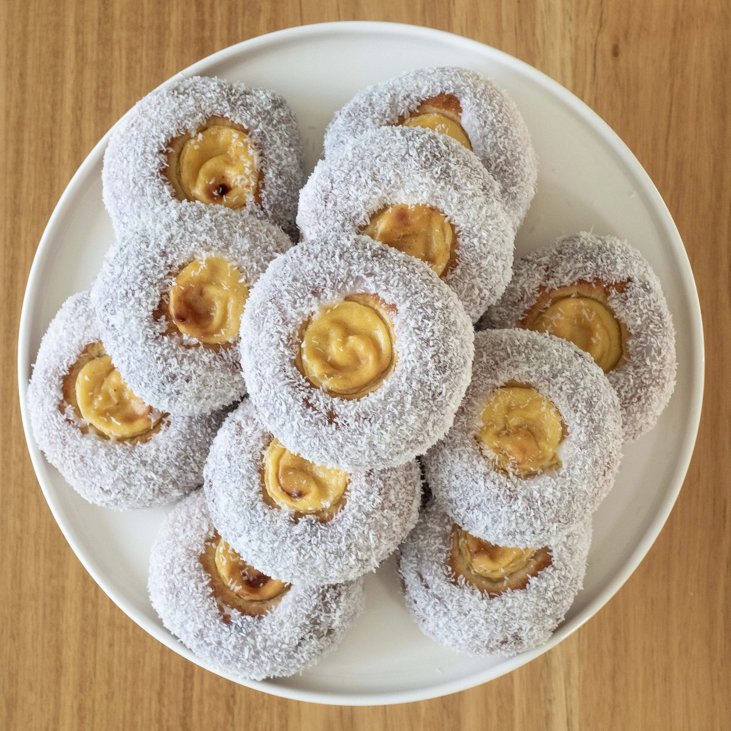 a pile of skolebrød or skolebolle norwegian cardamom, custard and coconut buns seen from above