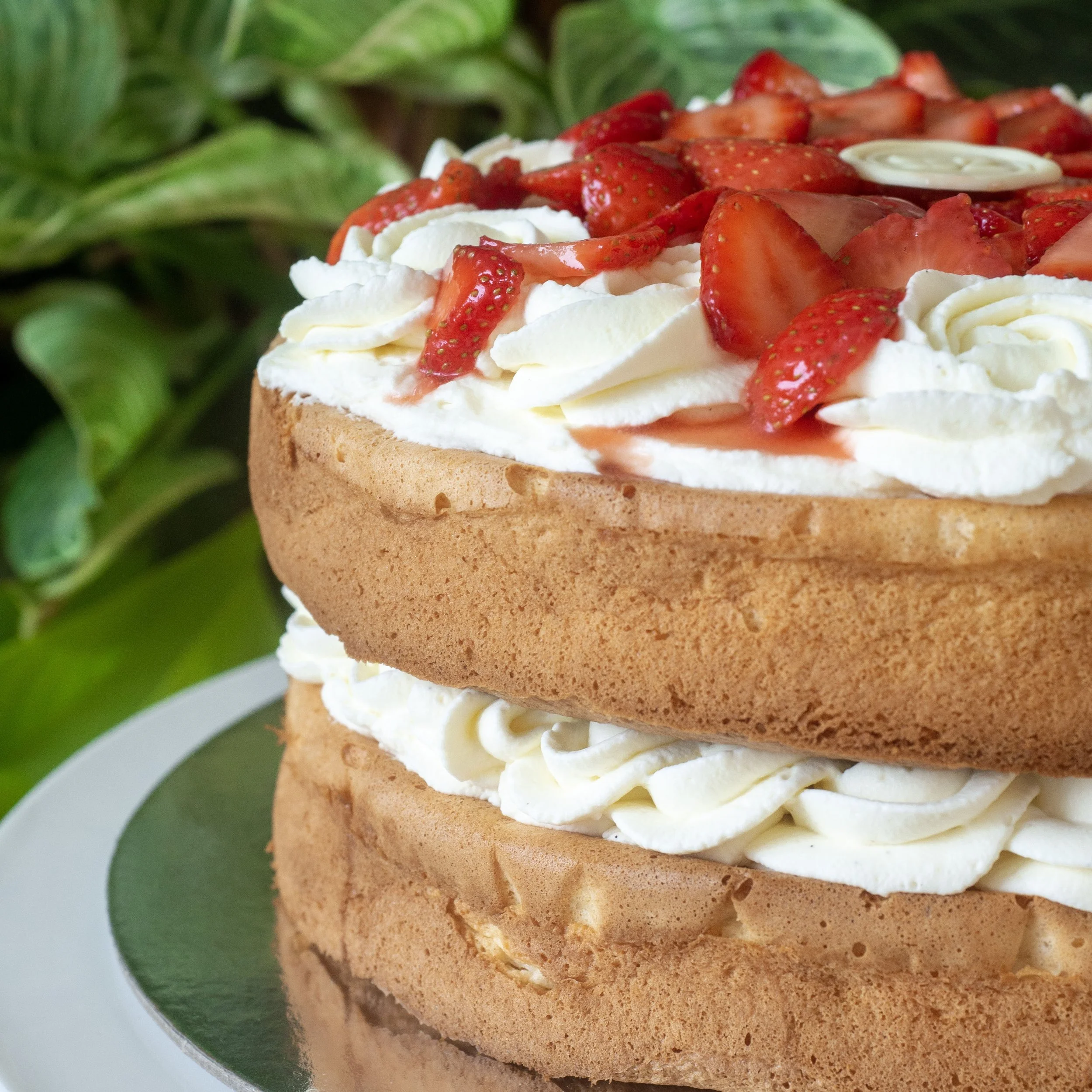 a fancy British Victoria Sponge with macerated strawberries