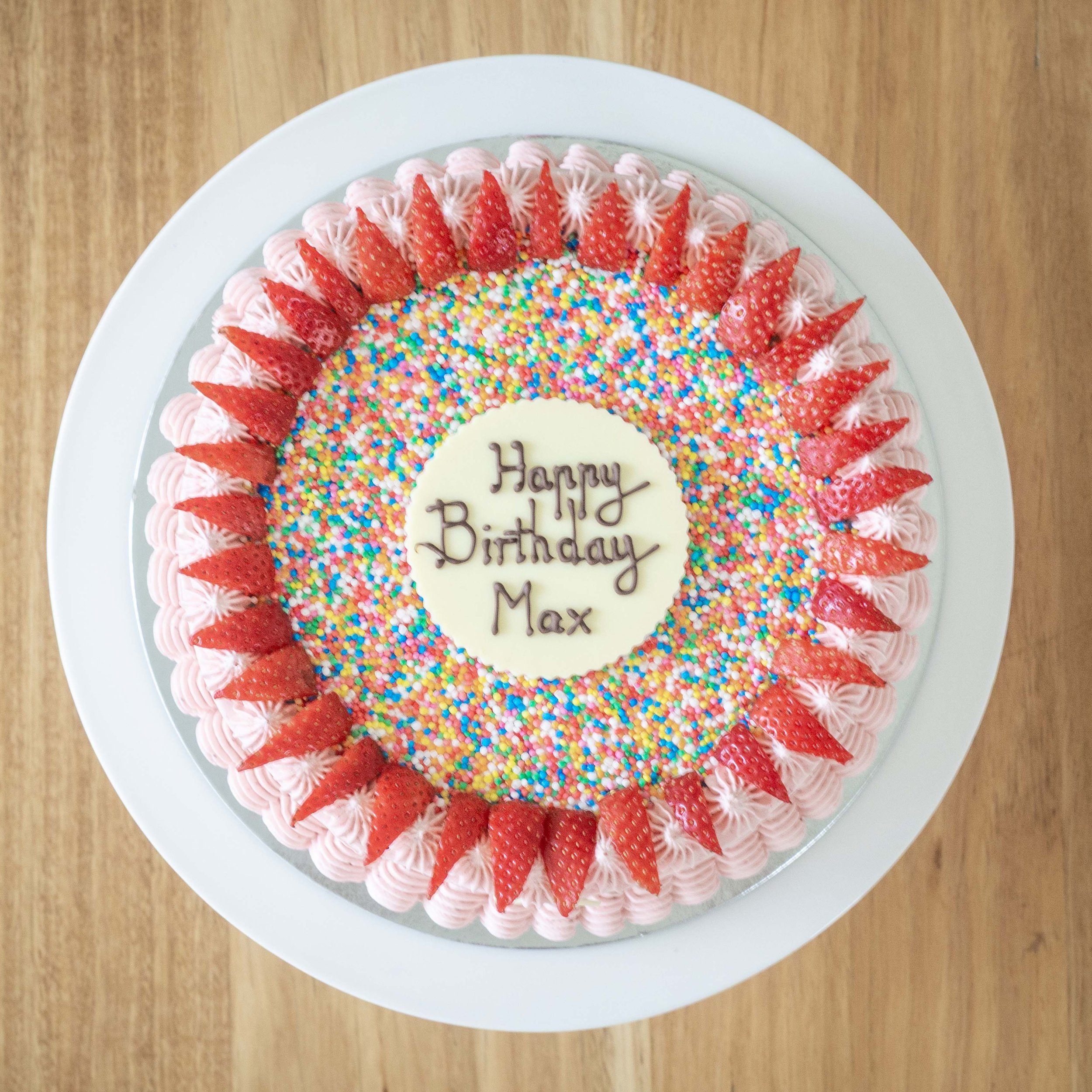 a view from above of a strawberry cake with sprinkles perfect for kids birthday parties
