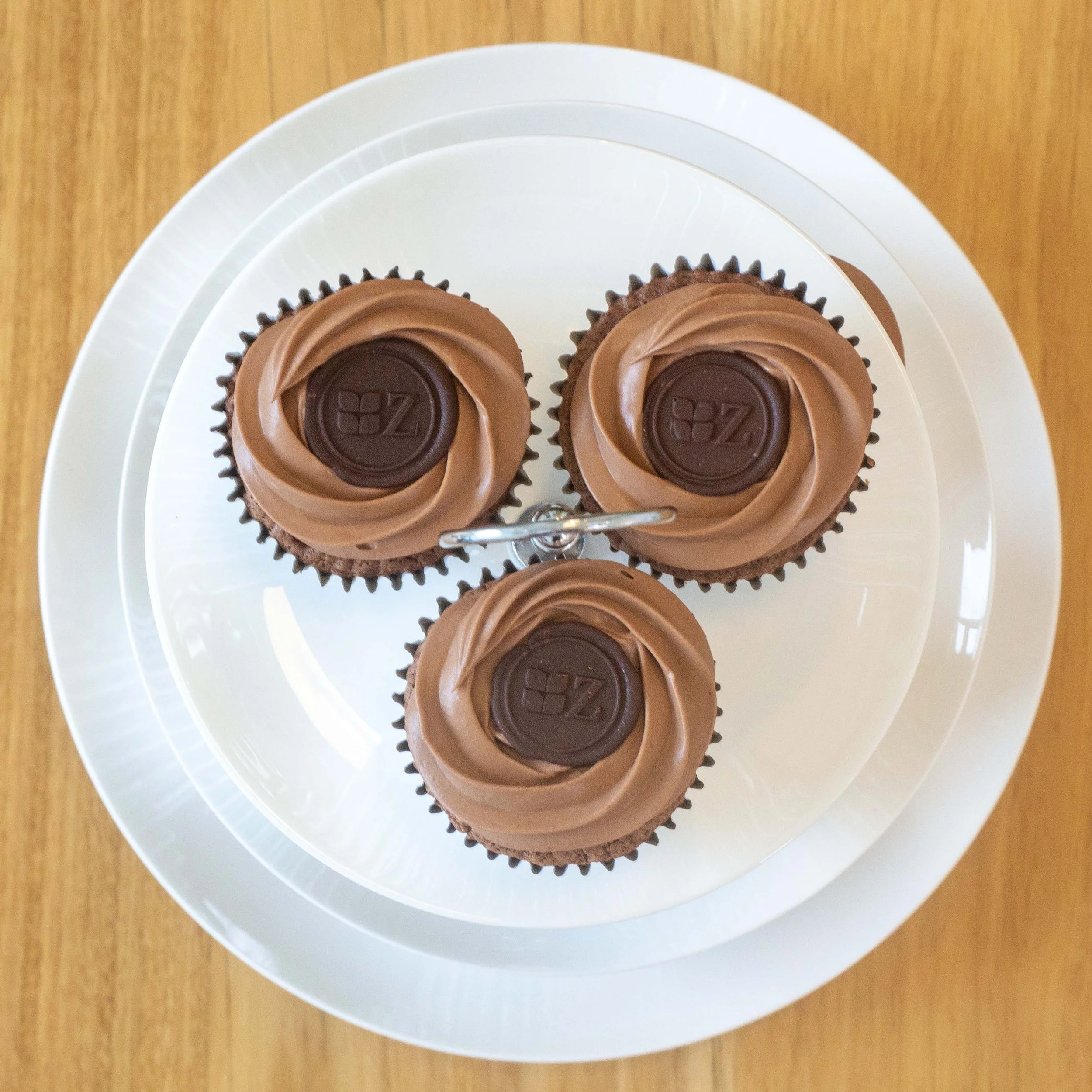 three sachertorte cupcakes seen from above