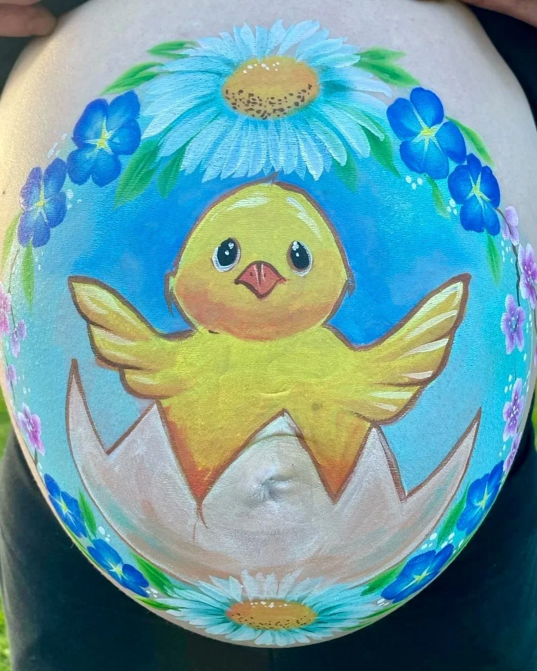Pregnant belly painted with little chick