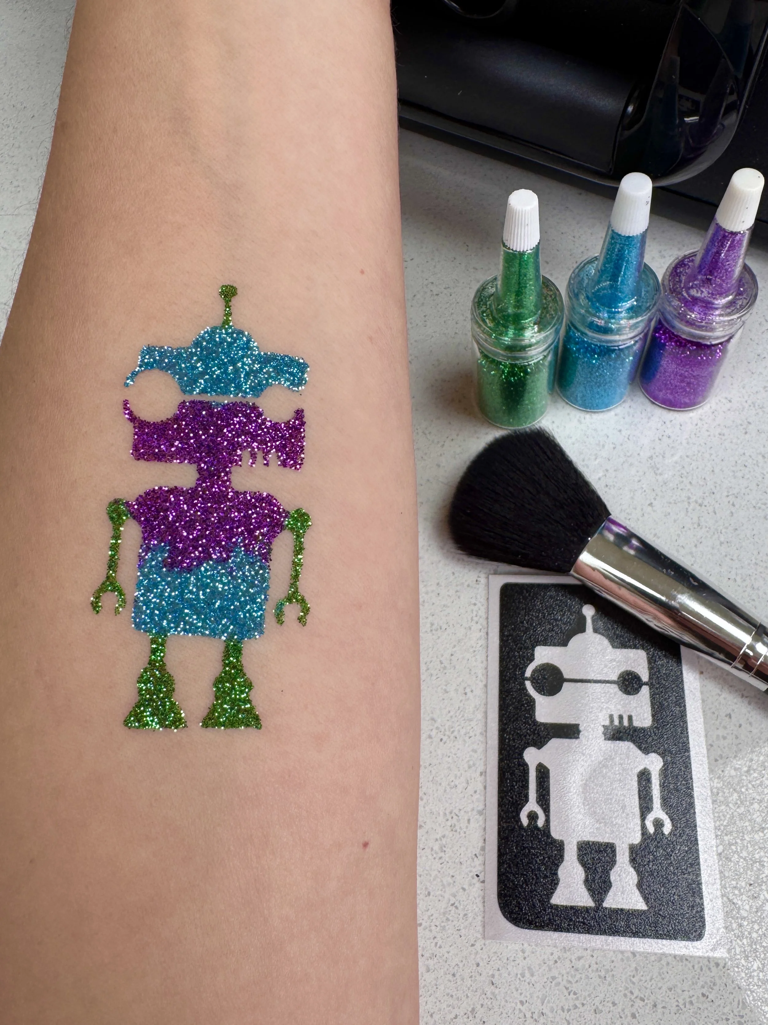 Arm with glitter tattoo of robot Oxford Face painter Parties 