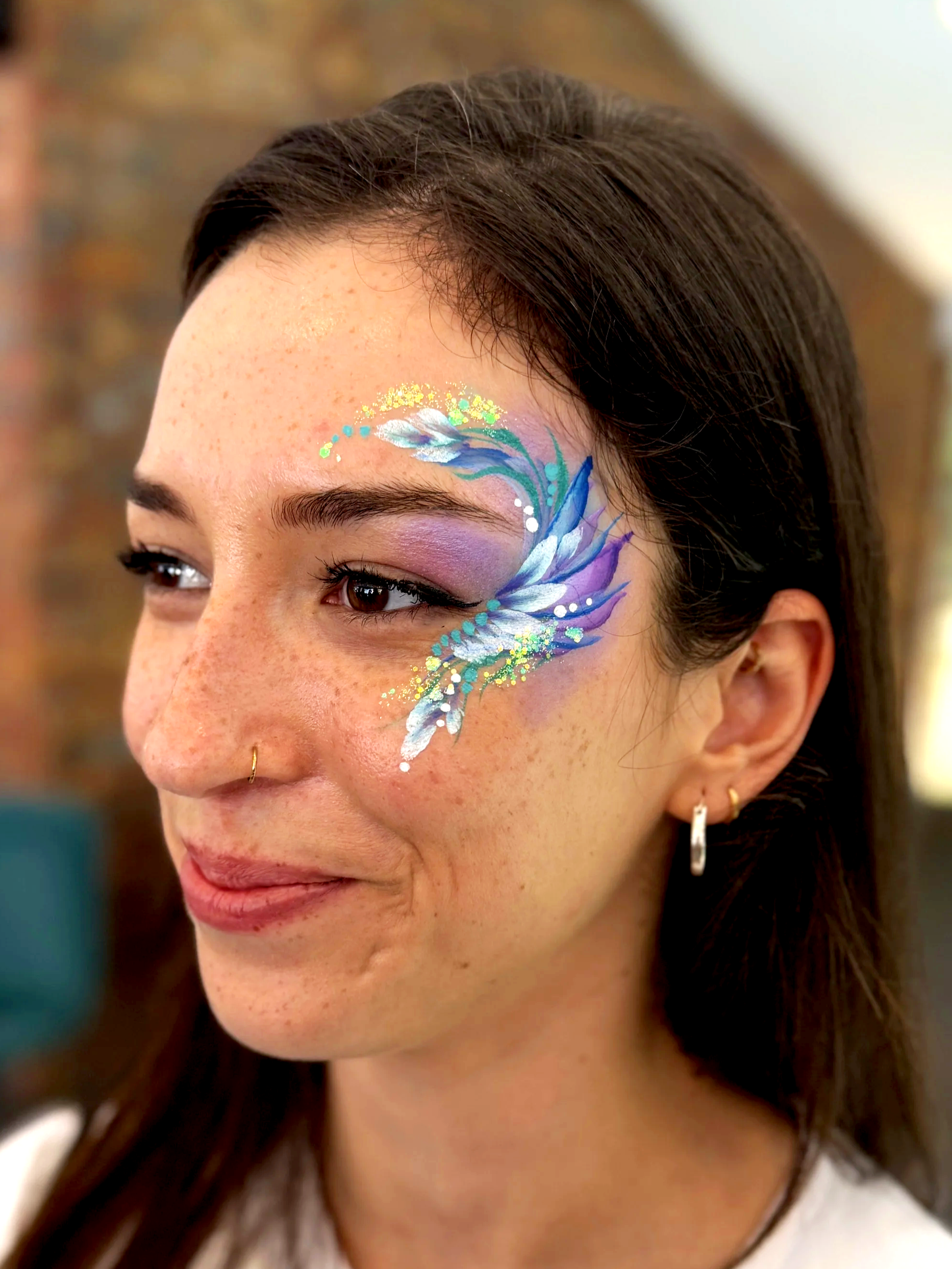 Woman with pretty purple, blue and green eye design