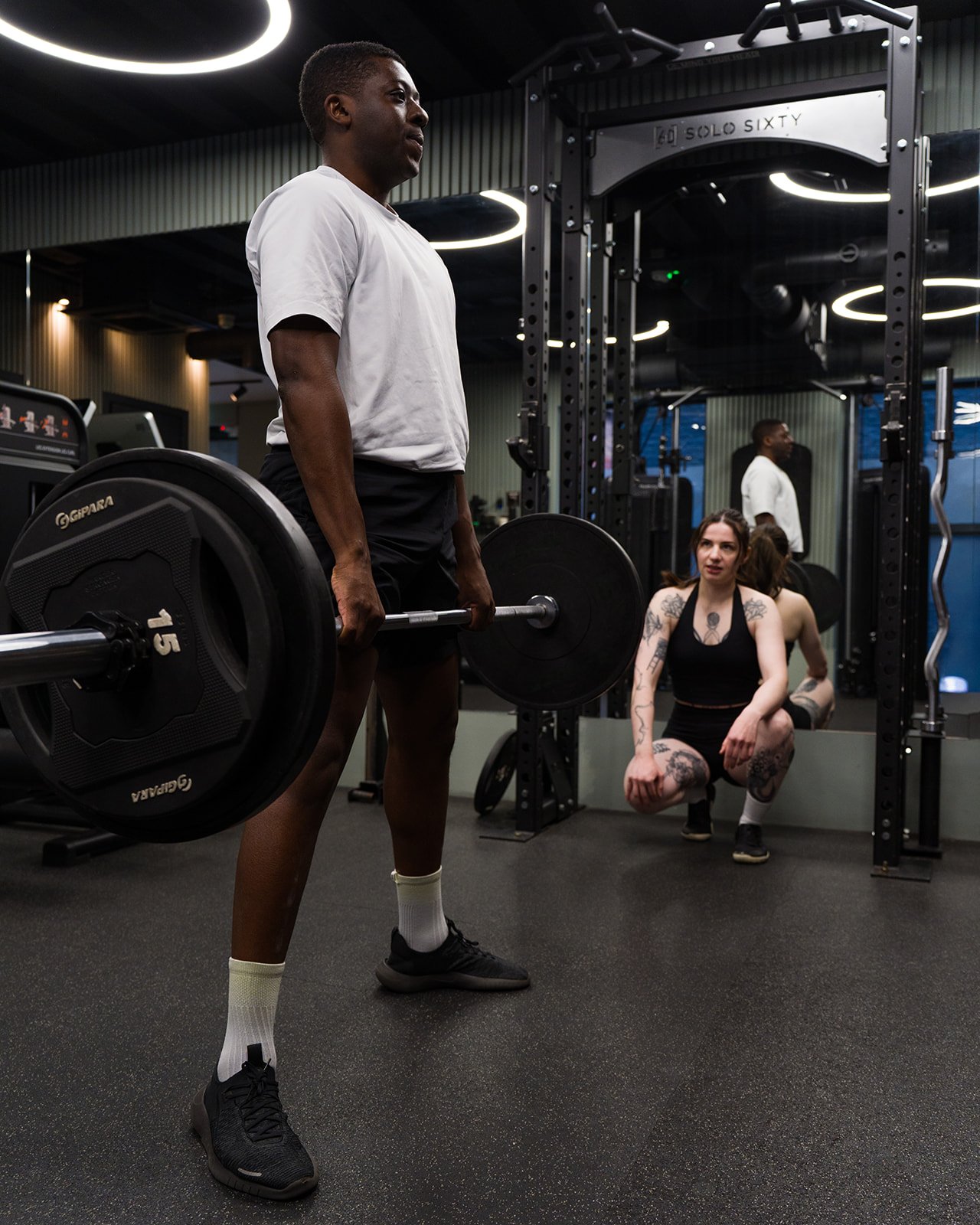 Nicolina observing a client performing a sumo deadlift