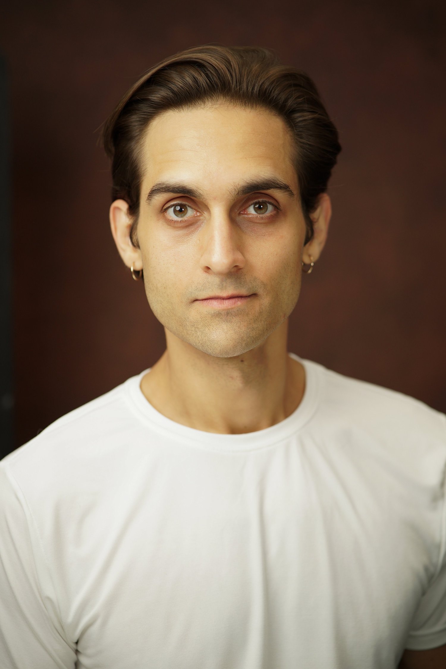 Milan Babi surprised expressive commercial headshot in white shirt