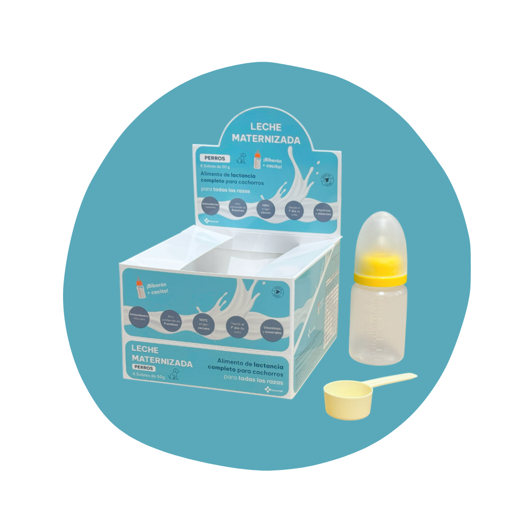 Lactancia completa en polvo para perros en caja azul, con biberón y cucharita medidora.
