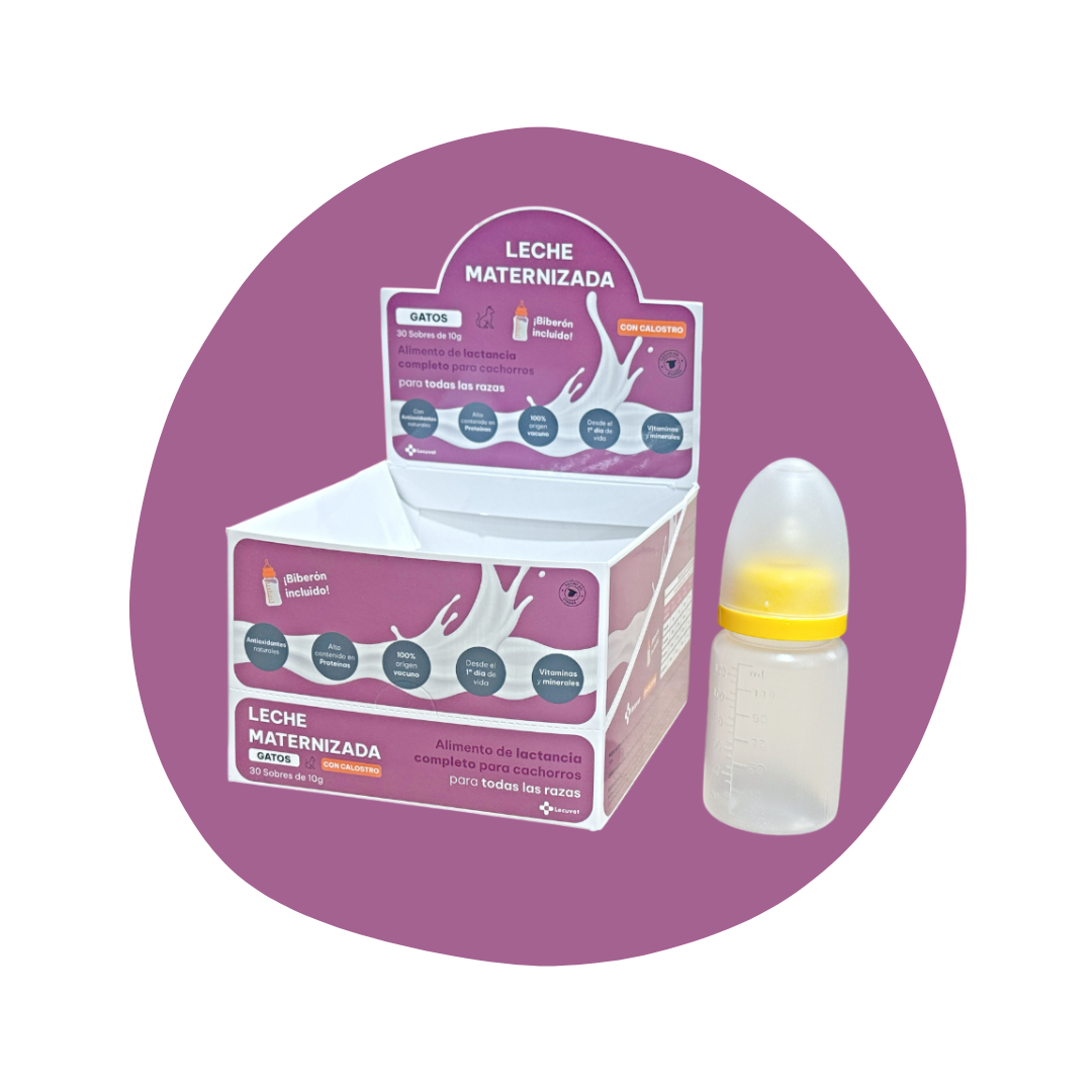 Leche materna en polvo para gatos en una caja rosa y una botella de biberón. La caja indica que es leche maternizada para cachorros de todas las razas, con calostro incluido.