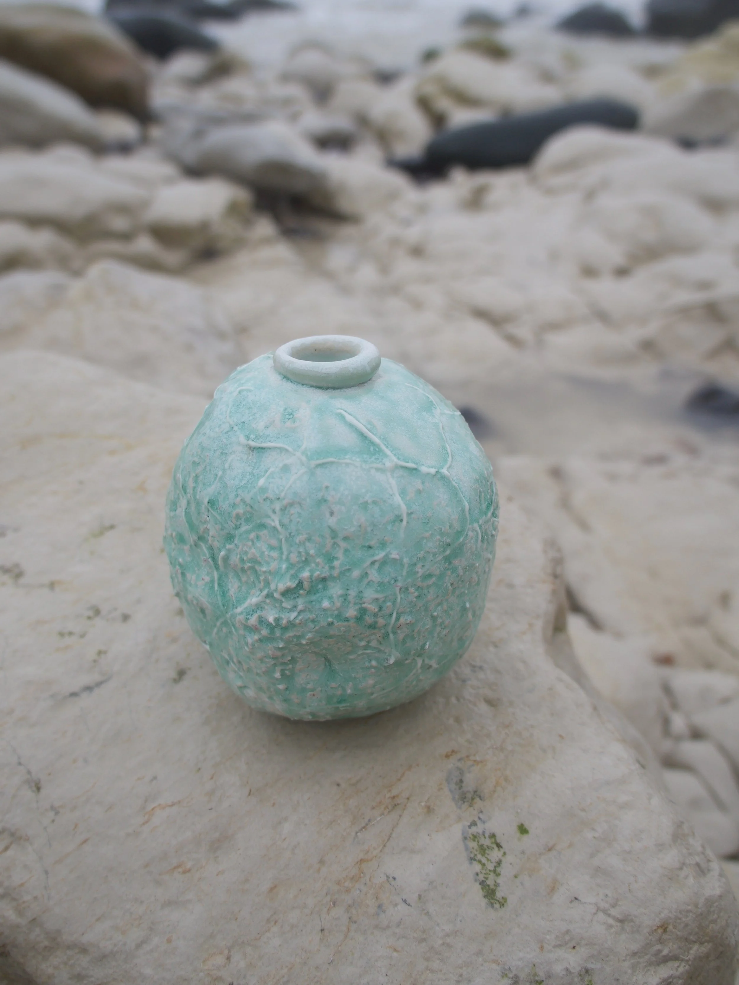 UNPOTE : Ocean Falling Tide No.3 
Handbuilt stoneware vessel shaped by the falling tide, rolled and pressed in ocean shallows. Its pale aqua ash glaze evokes the shimmer of retreating waves and the memory of saltwater light. Porcelain slip and wood a